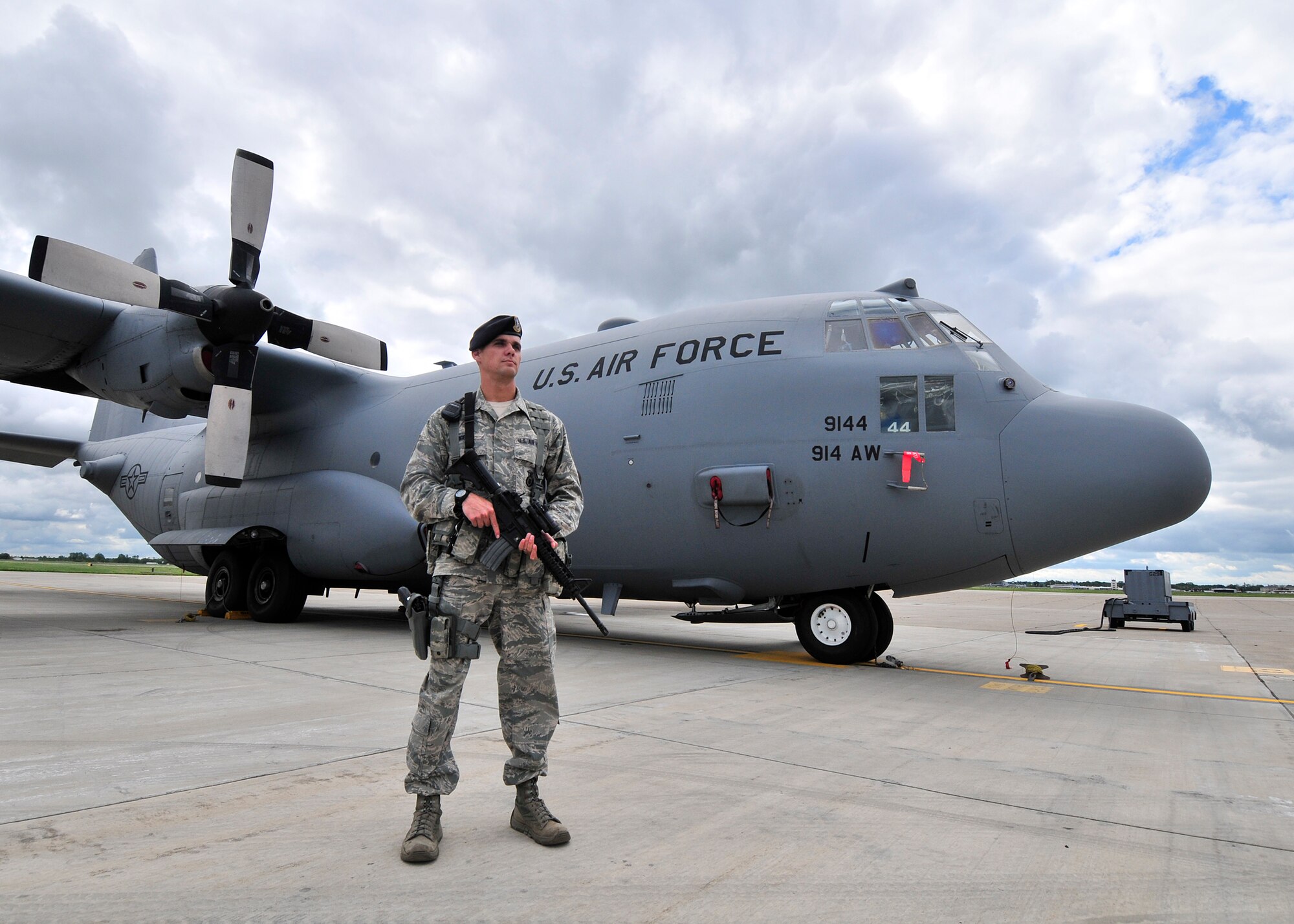 Staff Sgt. Matthew Higgins, 914th Security Forces Squadron member stands guard over a C-130 H2 aircraft at the Niagara Falls Air Reserve Station, N.Y.  on August 27, 2015. Higgins is one of many security forces personnel that maintain security on the flight line and help protect Air Force assets 24 hours a day 365 days a year.  (U. S. Air Force photo by Peter Borys)