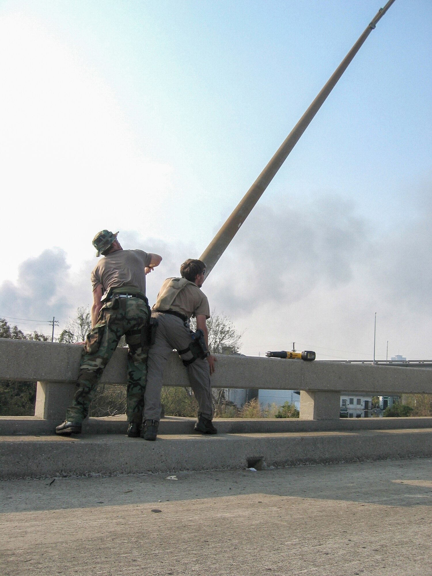 Special tactics troops from the Kentucky Air National Guard cut down street light poles along Interstate 610 in New Orleans following Hurricane Katrina Sept. 3, 2005, to clear the way for a helicopter landing zone. (U.S. Air National Guard photo)