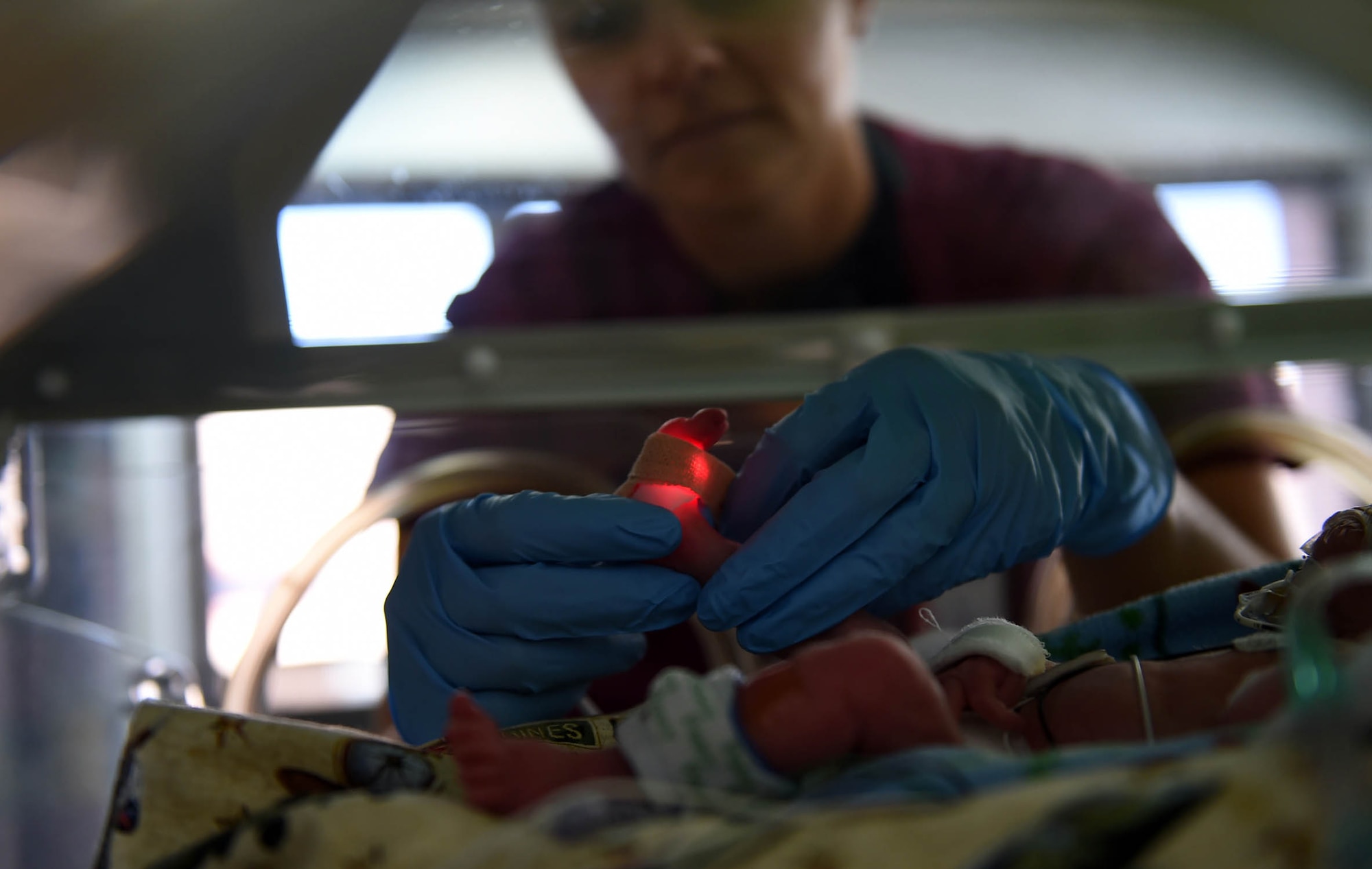 Capt. Mandie Yates, a registered nurse with the 959th Inpatient Operations Squadron, wraps an oxygen monitor around a baby’s foot Aug. 7, 2015, in the San Antonio Military Medical Center’s Neonatal Intensive Care Unit, Joint Base San Antonio-Fort Sam Houston. The NICU provides newborn health care and neonatal intensive care services to DoD beneficiaries while maintaining military readiness, education & training, and conducting research. (U.S. Air Force photo/Staff Sgt. Jerilyn Quintanilla)
