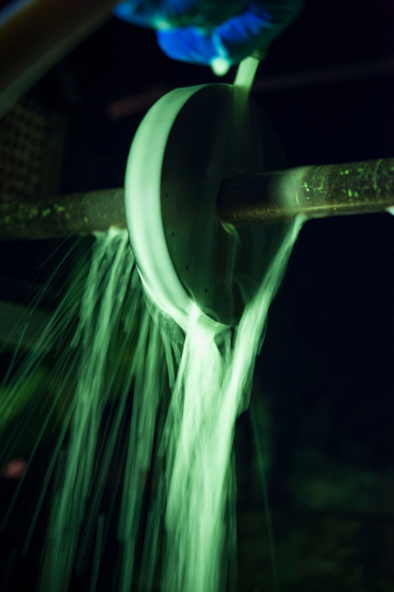 Senior Airman Kyle Abendroth, 5th Maintenance Squadron non-destructive inspection journeyman, uses a magnetic particle machine at Minot Air Force Base, N.D., Aug. 26, 2015. The magnetic particle machine magnetizes ferromagnetic metal parts, which are composed mostly of iron. Once magnetized any surface or subsurface cracks are made visible by a buildup of particles from the oil bath which glow under black light. (U.S. Air Force photo/Senior Airman Stephanie Morris)