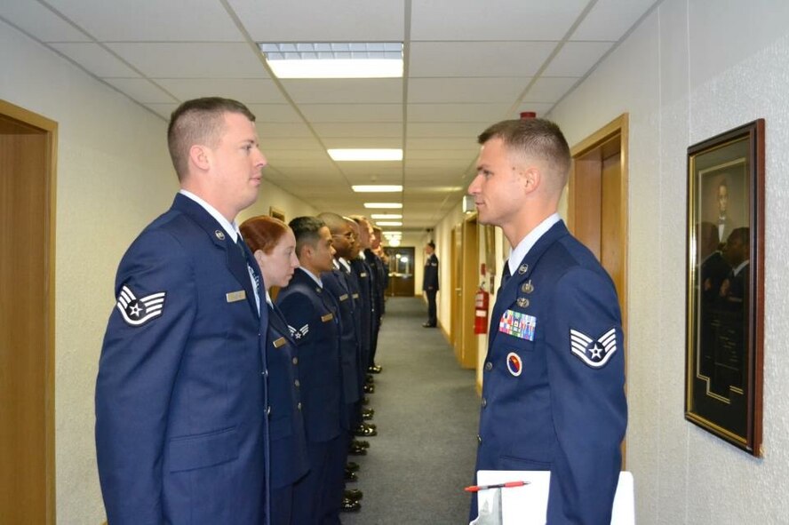 Tech Sgt. Noah Stamps, 432nd Wing/432nd air Expeditionary Wing command chief executive assistant, performs a uniform inspection as a staff sergeant while assigned to the Airman Leadership School Instructor at Ramstein Air Base, Germany.  During his time as an instructor, Sept. 2009 to Sept. 2012, Stamps graduated 22 classes of Airmen selected for the rank of staff sergeant. (Courtesy Photo) 