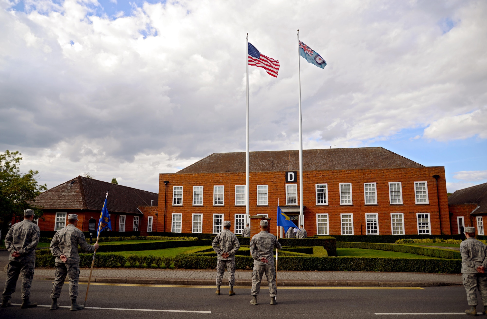 U.S. Air Force Air Commandos from the 352nd Special Operations Wing prepare for retreat Aug. 28, 2015, on RAF Mildenhall, England. Retreat is a ceremony symbolizing the end of the duty day as well as paying respect to the flags. This month’s retreat is to celebrate 2015’s Year of the Air Commando, marking the 25th anniversary of the activation of Air Force Special Operations Component  and 35th anniversary of Operation EAGLE CLAW; the failed Iranian hostage rescue crisis. (U.S. Air Force photo by Senior Airman Christine Halan/Released) 