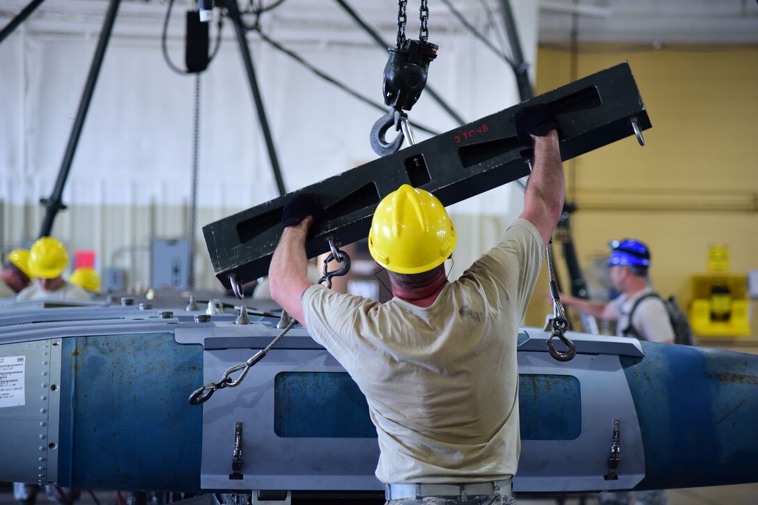 Staff Sgt. Josiah Thatcher, 28th Munitions Squadron munitions support bay chief, prepares to attach a hoist to transfer munitions during the Global Strike Challenge on Ellsworth Air Force Base S.D., Aug. 20, 2015. The competition is designed to improve combat capabilities through preparation, innovation, competition and teamwork. (U.S. Air Force photo by Airman 1st Class James L. Miller/Released)
