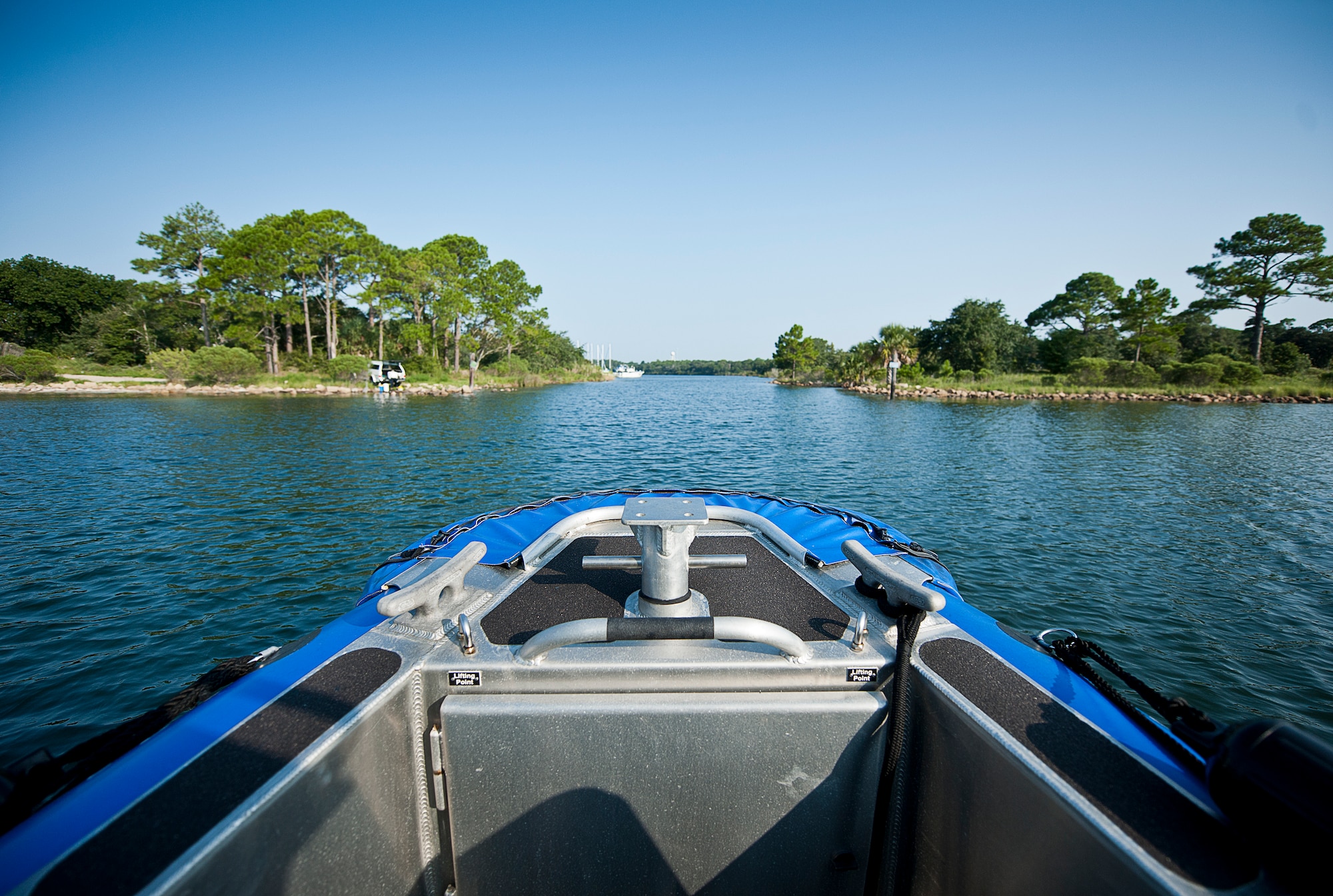 The 96th Security Forces Squadron boat moves through the water toward Ben’s Lake Marina during a patrol around the base’s shoreline Aug. 25 at Eglin Air Force Base, Fla.  Recently, a group of defenders became qualified to operate the boat through Coast Guard certification.  They are responsible for monitoring and security of Eglin’s 153 miles of coastline.  (U.S. Air Force photo/Samuel King Jr.)
