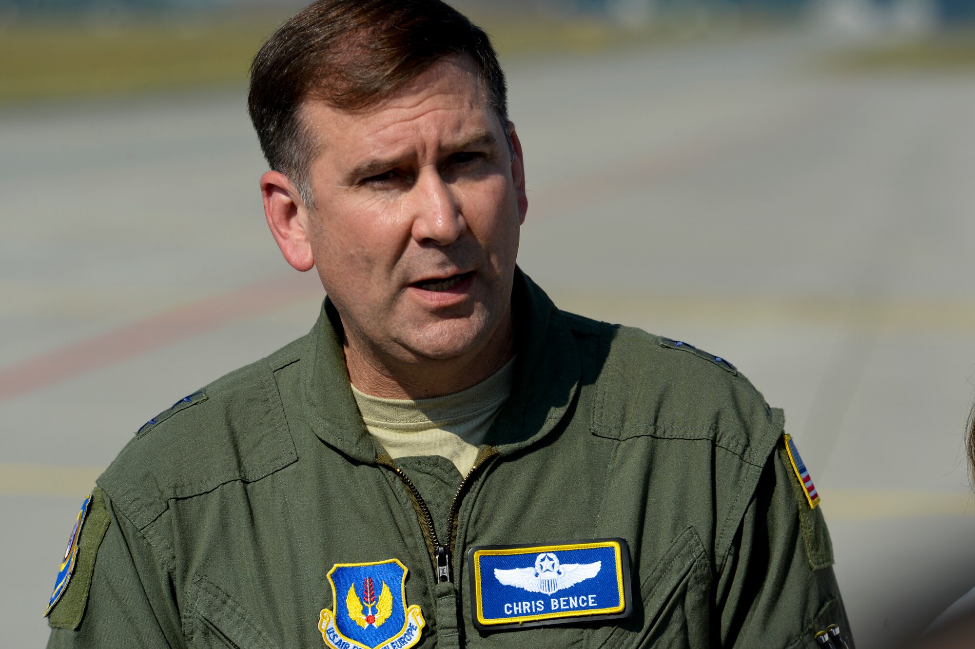U.S. Air Force Maj. Gen. Christopher Bence, 3rd Air Force and 17th Expeditionary Air Force vice commander, speaks during a press conference on the flightline at Lask Air Base, Poland, Aug. 31, 2015. The general discussed the inaugural F-22 training deployment to Europe and is funded by the European Reassurance Initiative, which is intended to increase the capability, readiness and responsiveness of NATO forces in part by funding rotational force presence in Eastern Europe. (U.S. Air Force photo by Staff Sgt. Joe W. McFadden/Released)