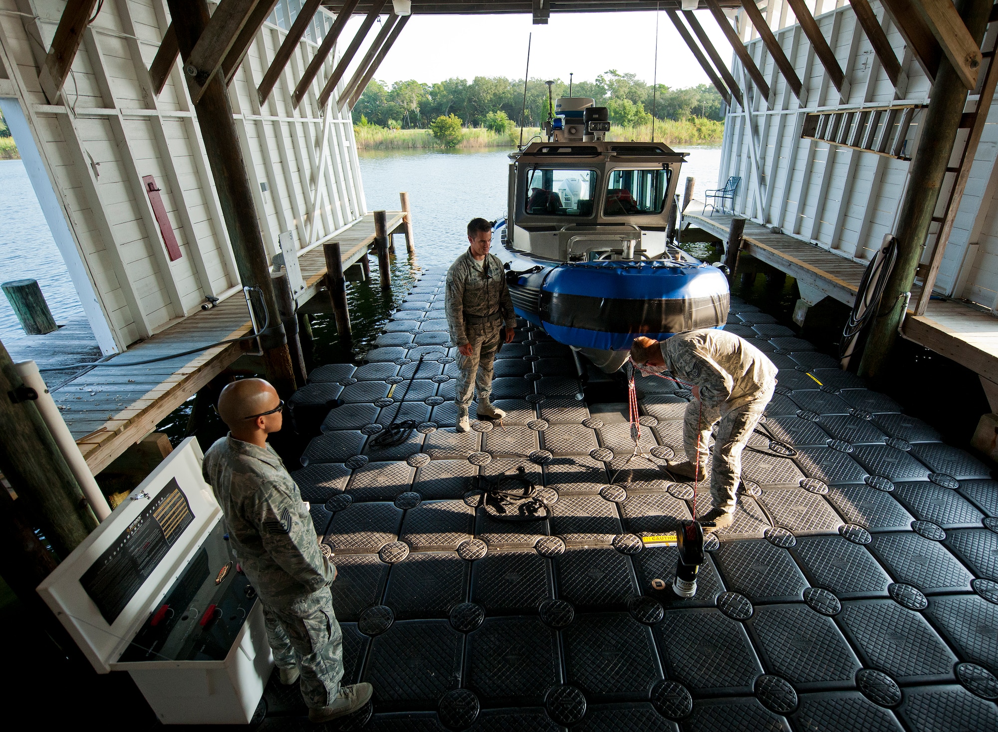 Airmen with the 96th Security Forces Squadron prepare to take out the squadron’s boat to patrol around the base’s shoreline Aug. 25 at Eglin Air Force Base, Fla.  Recently, a group of defenders became qualified to operate the boat through Coast Guard certification.  They are responsible for monitoring and security of Eglin’s 153 miles of coastline.  (U.S. Air Force photo/Samuel King Jr.)