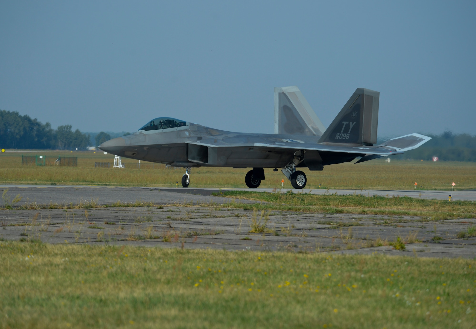 A U.S. Air Force F-22 Raptor taxis on the flightline at Lask Air Base, Poland, Aug. 31, 2015. The deployment represents the inaugural F-22 training deployment to Europe and is funded by the European Reassurance Initiative, which is intended to increase the capability, readiness and responsiveness of NATO forces in part by funding rotational force presence in Eastern Europe. (U.S. Air Force photo by Staff Sgt. Joe W. McFadden/Released)
