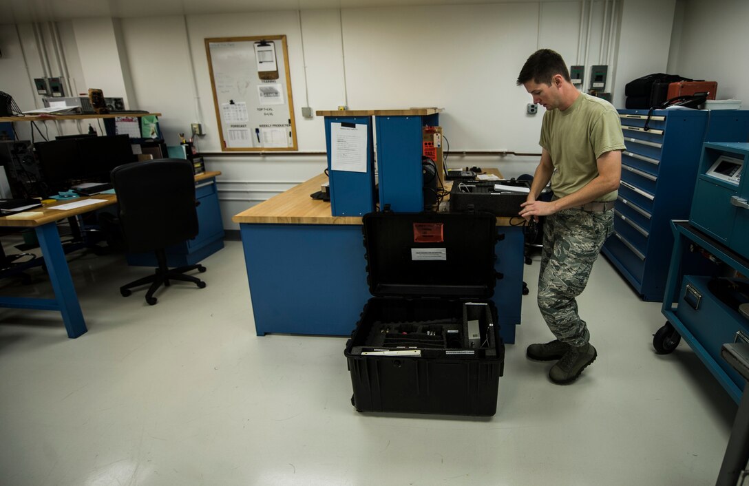 U.S. Air Force Airman 1st Class Luke Goins, 1st Maintenance Squadron precision measurement equipment laboratory apprentice, calibrates a weight and balance kit at Langley Air Force Base, Va., Aug. 18, 2015. The PMEL specialists use quantitative measurements to calibrate different measurement equipment and service approximately 5,000 parts. (U.S. Air Force photo by Senior Airman Kayla Newman/Released)