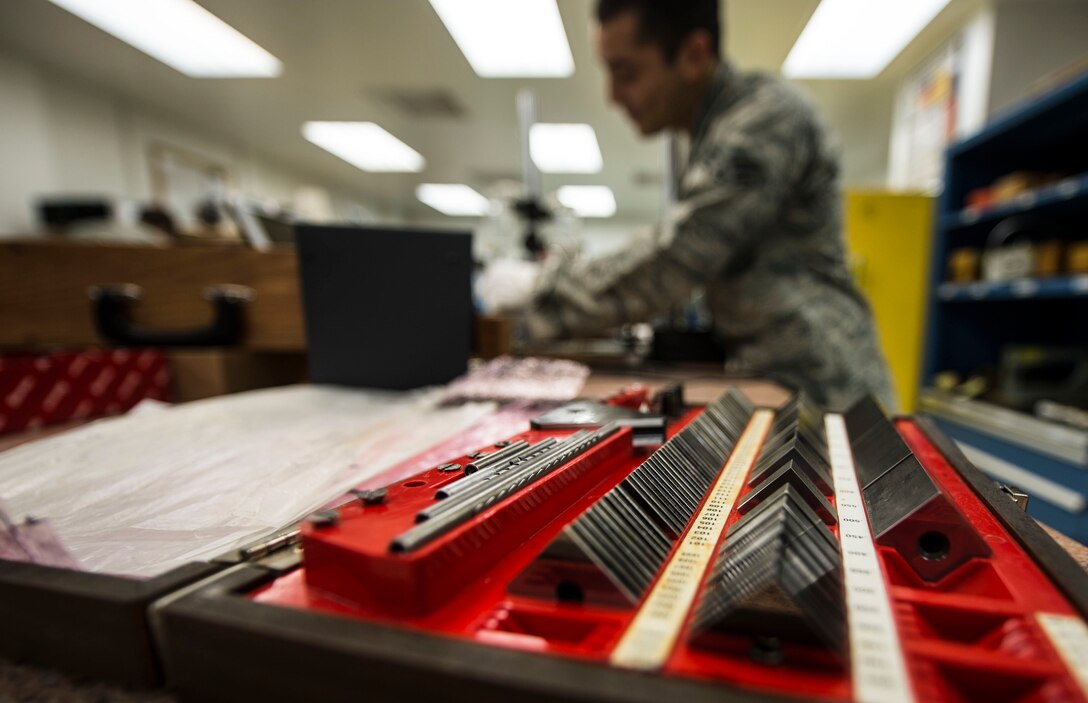 U.S. Air Force Senior Airman Ruben Mejia, 1st Maintenance Squadron precision measurement equipment laboratory journeyman, calibrates parallel bars at Langley Air Force Base, Va., Aug. 18, 2015. Langley PMEL specialists are responsible for the accuracy and tolerance of electronic and physical dimensional test equipment across the installation. (U.S. Air Force photo by Senior Airman Kayla Newman/Released))