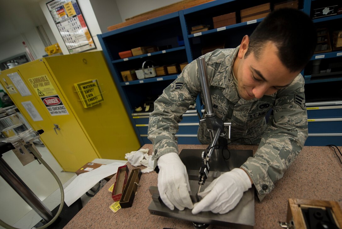 U.S. Air Force Senior Airman Ruben Mejia, 1st Maintenance Squadron precision measurement equipment laboratory journeyman, calibrates parallel bars at Langley Air Force Base, Va., Aug. 18, 2015. The PMEL flight consists of approximately 25 personnel who calibrate and repair measurement tools used across the installation. (U.S. Air Force photo by Senior Airman Kayla Newman/Released)