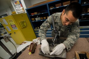 U.S. Air Force Senior Airman Ruben Mejia, 1st Maintenance Squadron precision measurement equipment laboratory journeyman, calibrates parallel bars at Langley Air Force Base, Va., Aug. 18, 2015. The PMEL flight consists of approximately 25 personnel who calibrate and repair measurement tools used across the installation. (U.S. Air Force photo by Senior Airman Kayla Newman/Released)