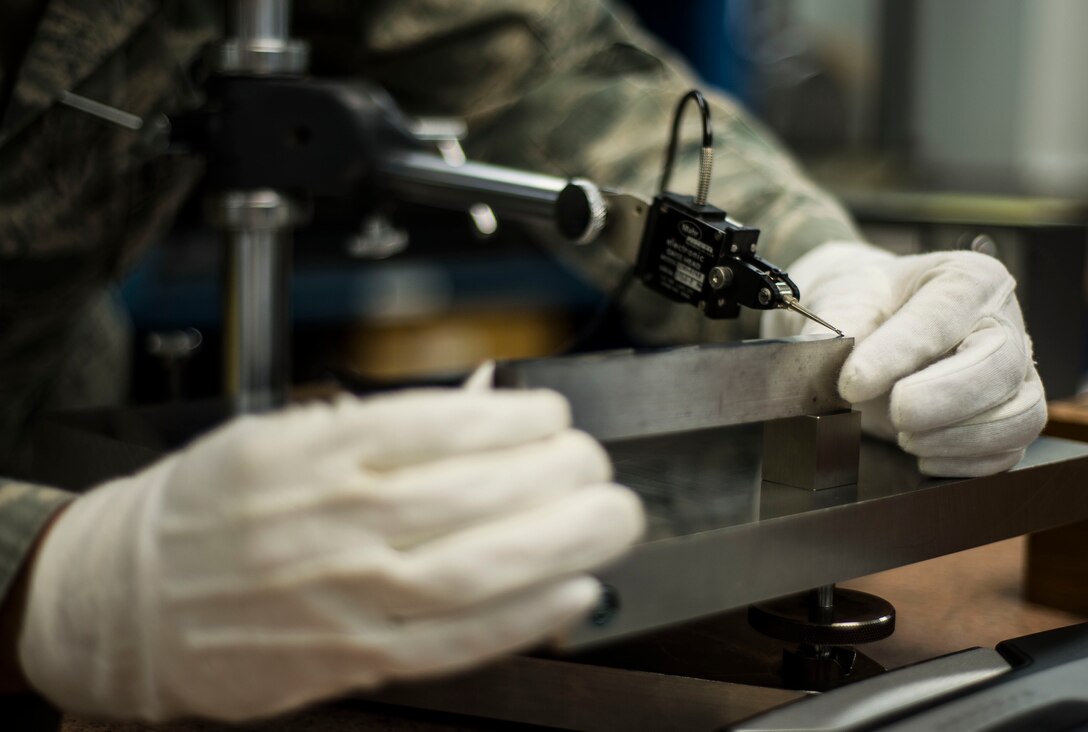 A U.S. Air Force Senior Airman Ruben Mejia, 1st Maintenance Squadron precision measurement equipment laboratory journeyman, calibrates parallel bars at Langley Air Force Base, Va., Aug. 18, 2015. Langley PMEL specialists at Langley service approximately 119 customers, to include Air Combat Command and the U.S. Coast Guard. (U.S. Air Force photo by Senior Airman Kayla Newman/Released)