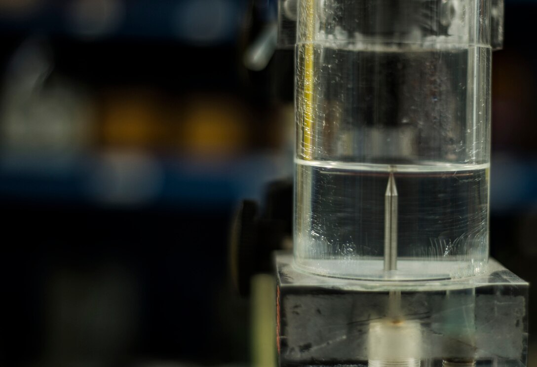 An obsolete inches-of-water-gauge calibrator is updated with a digital standard at Langley Air Force Base, Va., Aug. 18, 2015. The unit can generate one to 24 inches of water pressure in order to get accurate readings on water levels. (U.S. Air Force photo by Senior Airman Kayla Newman/Released)