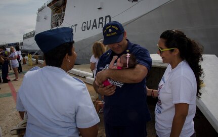 A United States Coast Guard Cutter James crew member is reunited with his wife and newborn baby daughter during the cutter's inaugural homecoming in Charleston, S.C. Aug. 28, 2015. The James is the fifth of eight planned National Security Cutters – the largest and most technologically advanced class of cutters in the Coast Guard’s fleet. (U.S. Air Force photo/Staff Sgt. AJ Hyatt)