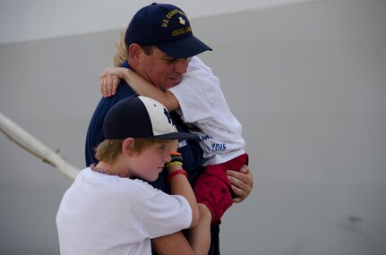 A United States Coast Guard Cutter James crew member is reunited with family members during the cutter's inaugural homecoming to Charleston, S.C. Aug. 28, 2015. The James is the fifth of eight planned National Security Cutters – the largest and most technologically advanced class of cutters in the Coast Guard’s fleet. (U.S. Air Force photo/Staff Sgt. AJ Hyatt)