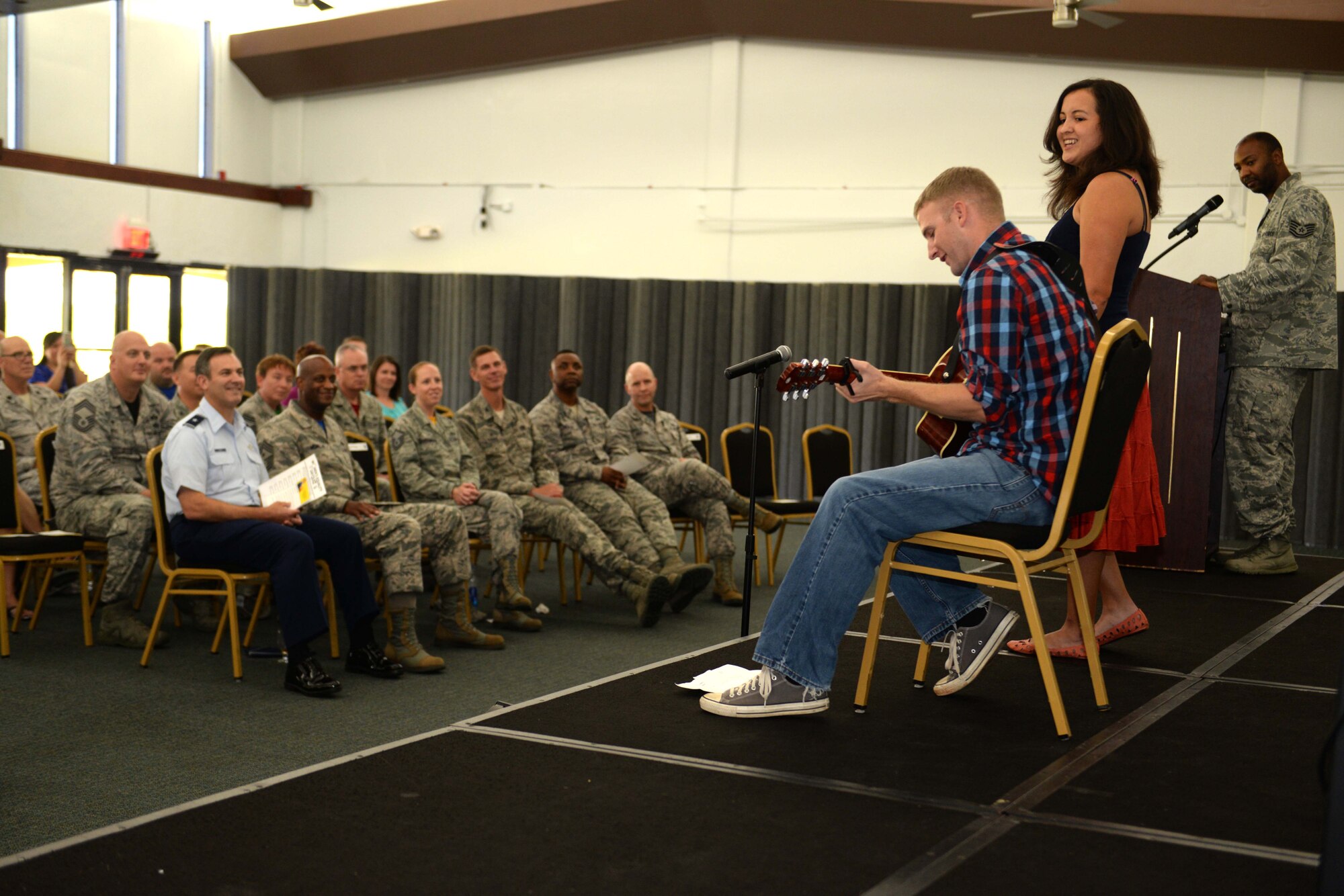 Robin Ellis (right), volunteer, sings as Staff Sgt. Adam Burley, 36th Mobility Response Squadron, plays the guitar during the Women’s Equality Day social Aug. 28, 2015, at Andersen Air Force Base, Guam. This year’s Women’s Equality Day marked the 95th anniversary of the 19th Amendment, which gave women the right to vote in 1920. (U.S. Air Force photo by Airman 1st Class Alexa Ann Henderson/Released)