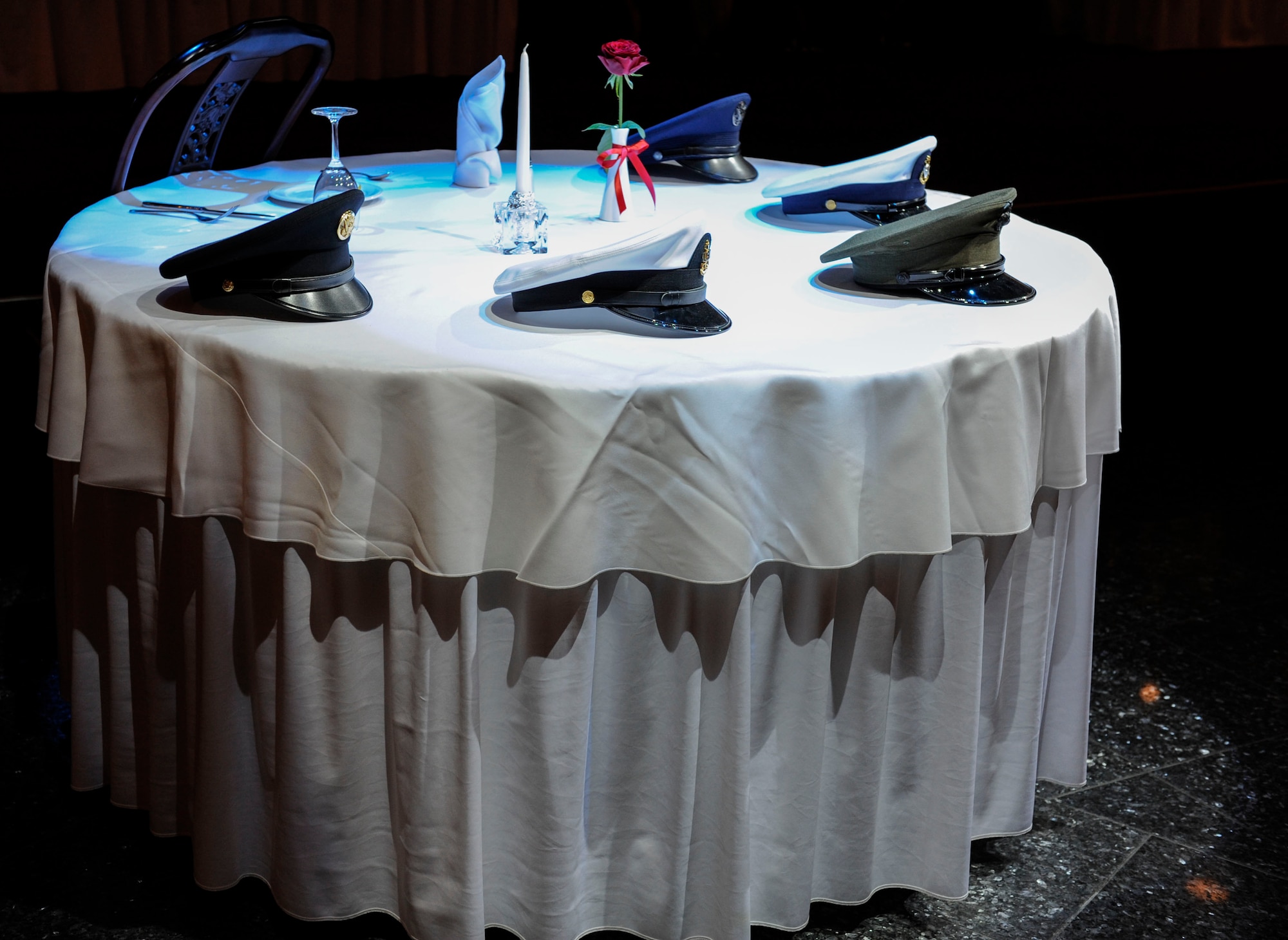 The prisoner of war/missing in action table is set for the Senior NCO induction ceremony Aug. 28, 2015, on Kadena Air Base, Japan. This table symbolizes the absence of fellow brothers and sisters in arms who are POWs and MIAs. Each article on the table has its own significance and is set to honor the POWs and MIAs. (U.S. Air Force photo by Airman 1st Class Lynette M. Rolen)
