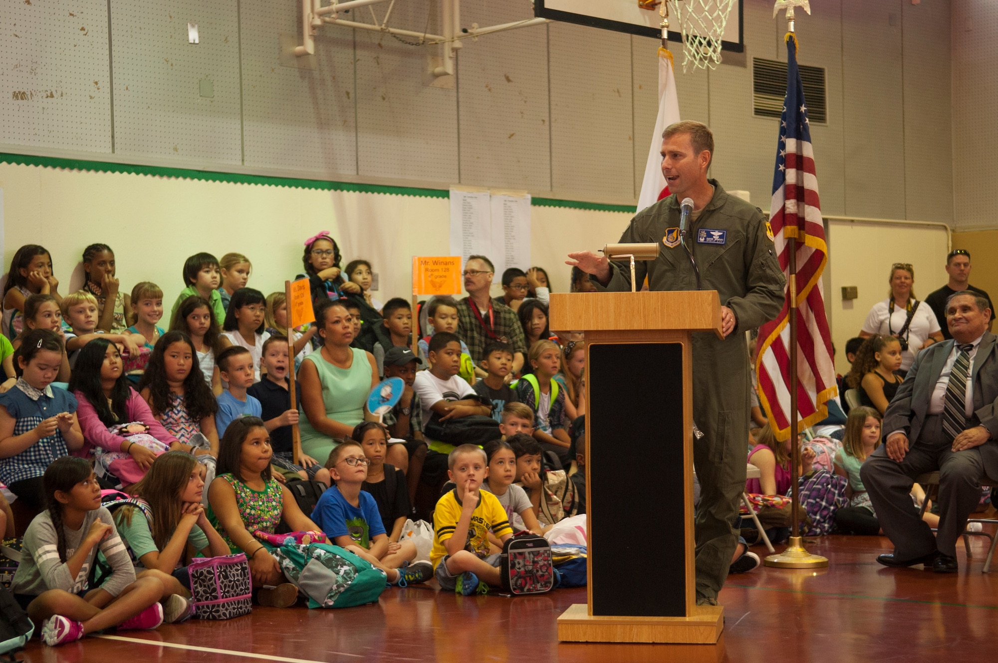 U.S. Air Force Col. David A. Mineau, 18th Operations Group commander, along with Wendy Cooley, Amelia Earhart Intermediate School principal and Michael Thompson, Department of Defense Education Association Okinawa superintendent, “drum in the new year” with the Taiko drums on Kadena Air Base, Japan, Aug. 31, 2015. Mineau stopped by during the ceremony to offer a few words of encouragement as students start the new year. (U.S. Air Force photo by Airman 1st Class Zackary A. Henry)