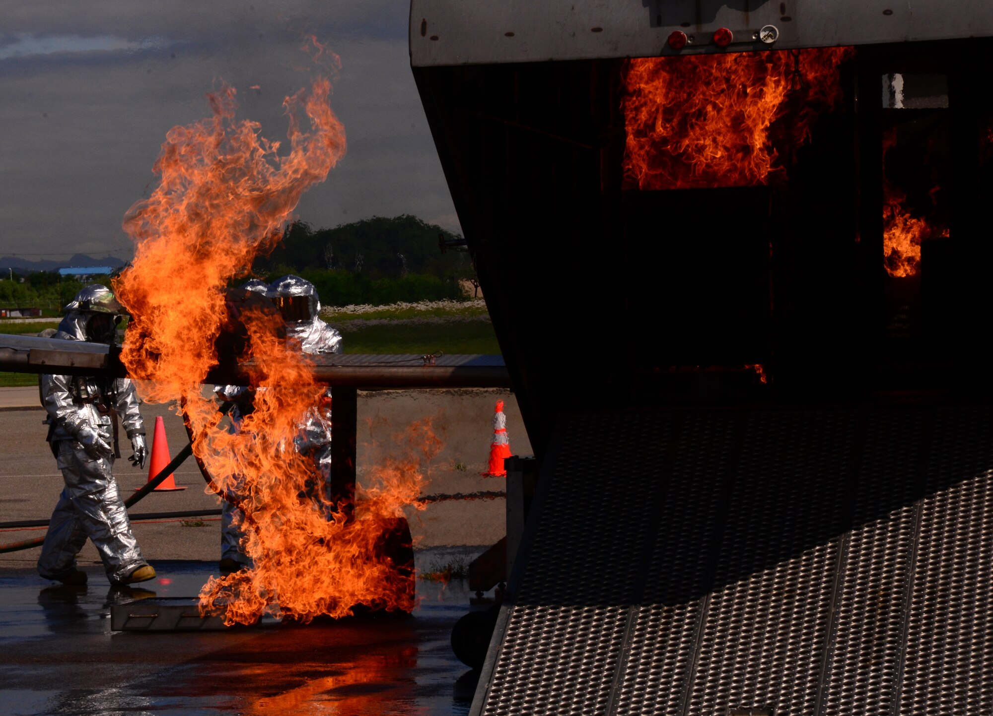 Firefighters assigned to the 51st Civil Engineer Squadron perform a training event with members of the Republic of Korea air force and Songtan fire stations Aug 26, 2015, at Osan Air Base, Republic of Korea. The goals of the training were to strengthen partnerships and provide unique aircraft training for all involved. (U. S. Air Force photo by Staff Sgt. Benjamin Sutton) 