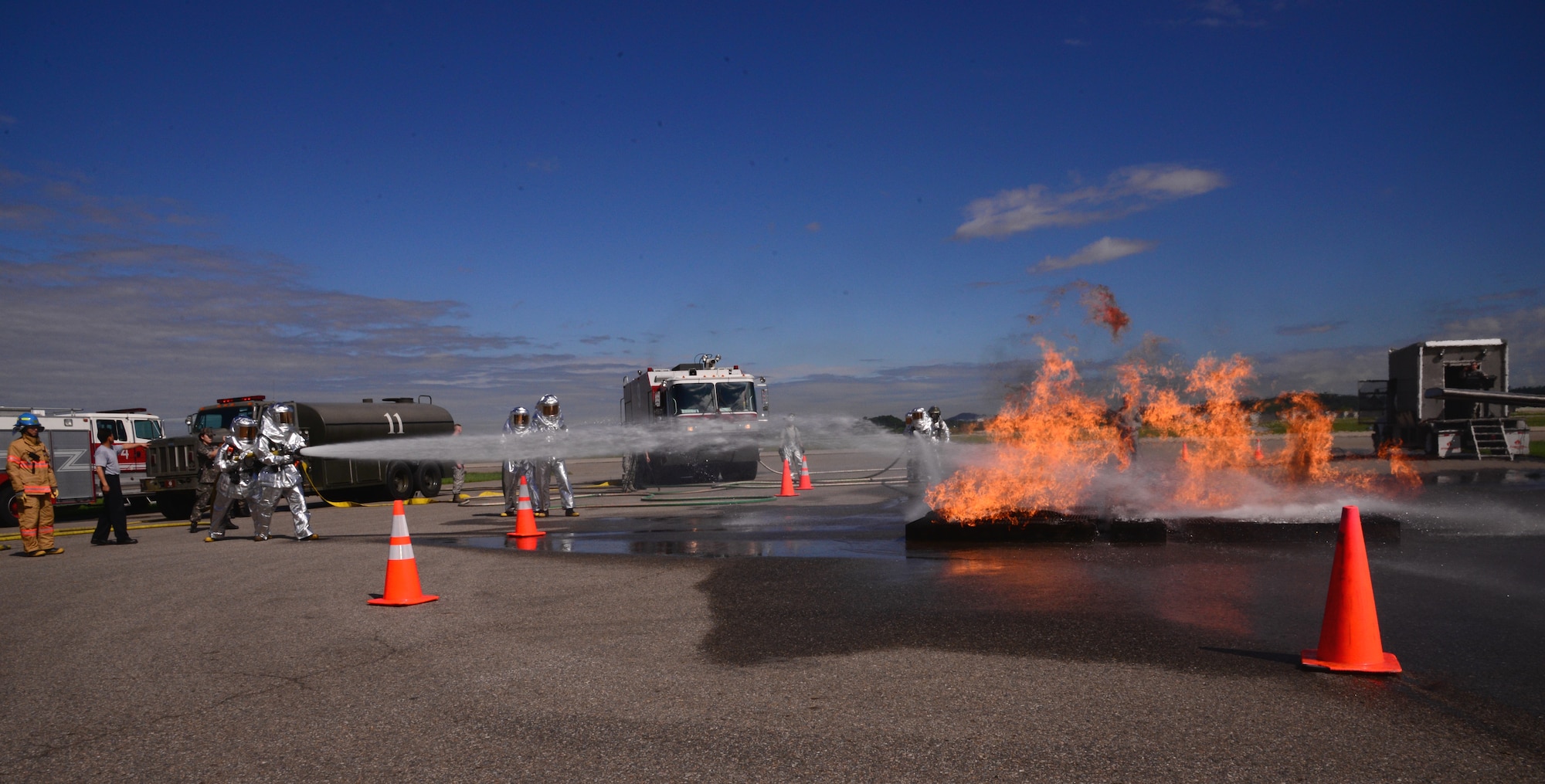 Firefighters from the 51st Civil Engineer Squadron assist Republic of Korea air force firefighters and members of the Songtan fire station practice their fire-sweeping techniques on a simulated fuel fire during a training exercise Aug 26, 2015, at Osan Air Base, Republic of Korea. During emergencies and humanitarian assistance operations, a strong relationship between first-responders is vital to ensuring safety for the entire community. (U. S. Air Force photo by Staff Sgt. Benjamin Sutton) 