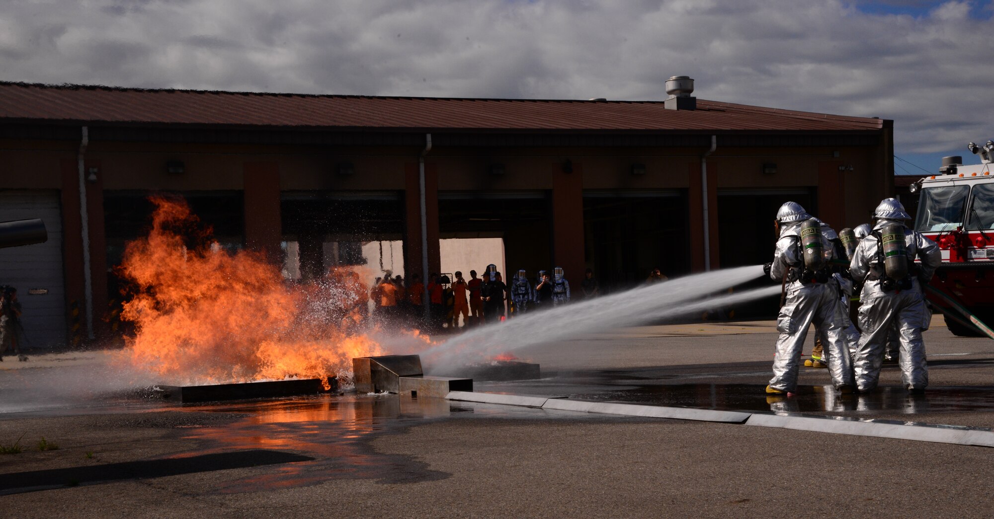 Firefighters from the Songtan fire station practice sweeping away and putting out a simulated fuel fire outside of a training aircraft Aug 26, 2015, at Osan Air Base, Republic of Korea. In the event of an aircraft emergency off-base, this training will assist local firefighters in safely containing and putting out any fire which could potentially occur. (U. S. Air Force photo by Staff Sgt. Benjamin Sutton) 
