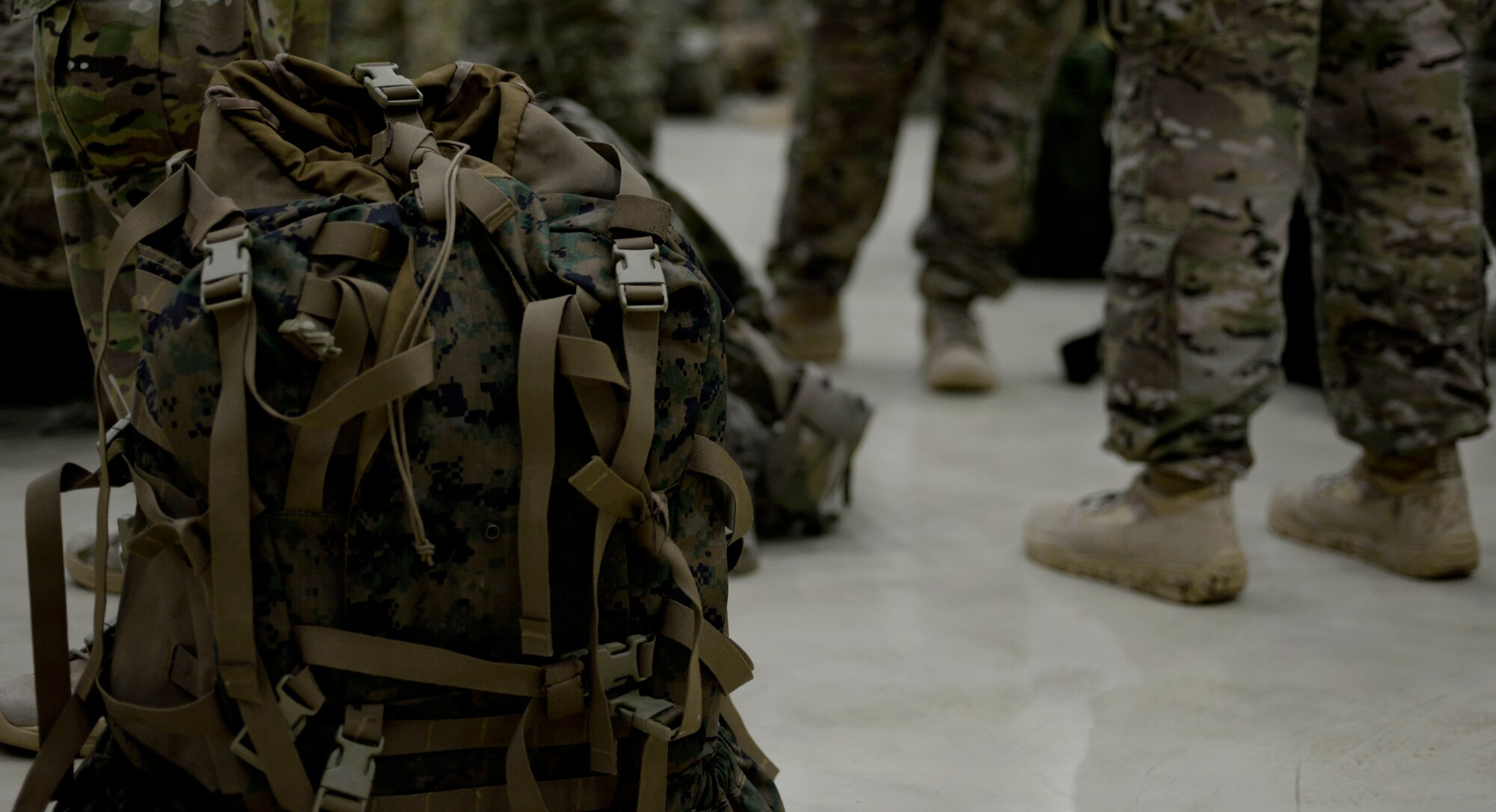 Rucksacks lay on the floor of Hangar 803 prior to a ruck march in honor of the “Year of the Air Commando” Nov. 30, 2015, on RAF Mildenhall, England. Those who participated where encouraged challenge themselves by carrying a rucksack with approximately 10 to 15 percent of their bodyweight. (U.S. Air Force photo by Senior Airman Victoria H. Taylor/Released)