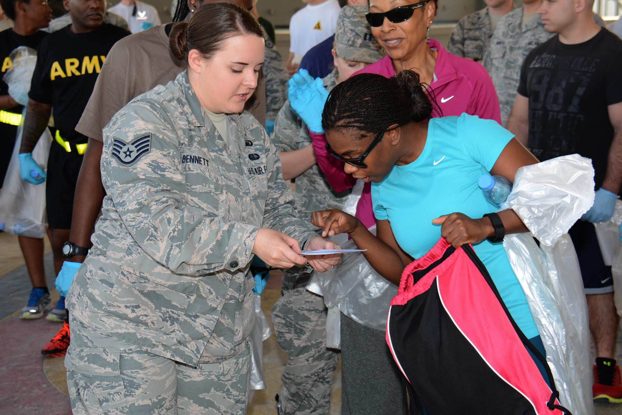 Staff Sgt. Amanda Bennett, 379th Air Expeditionary Wing chaplain assistant, explains to Staff Sgt. Jillion Clark, 379th Operations Support Squadron air traffic controller, the area she’ll be responsible for during an Operation Community clean-up event at Al Udeid Air Base, Qatar Dec. 1. The program is an effort to clean living areas on base and ultimately, make the best a better place, Bennett said. (U.S. Air Force photo by Tech. Sgt. James Hodgman/Released)