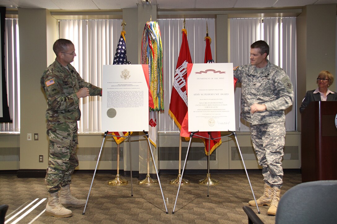 U.S. Army Corps of Engineers North Atlantic Division Commander Brig. Gen. William H. Graham (left) and New York District Commander Col. David A. Caldwell (right) during an unveiling ceremony honoring New York District employees with the Army Superior Unit Award for excellence in recovery efforts following Hurricane Sandy in fall 2012.