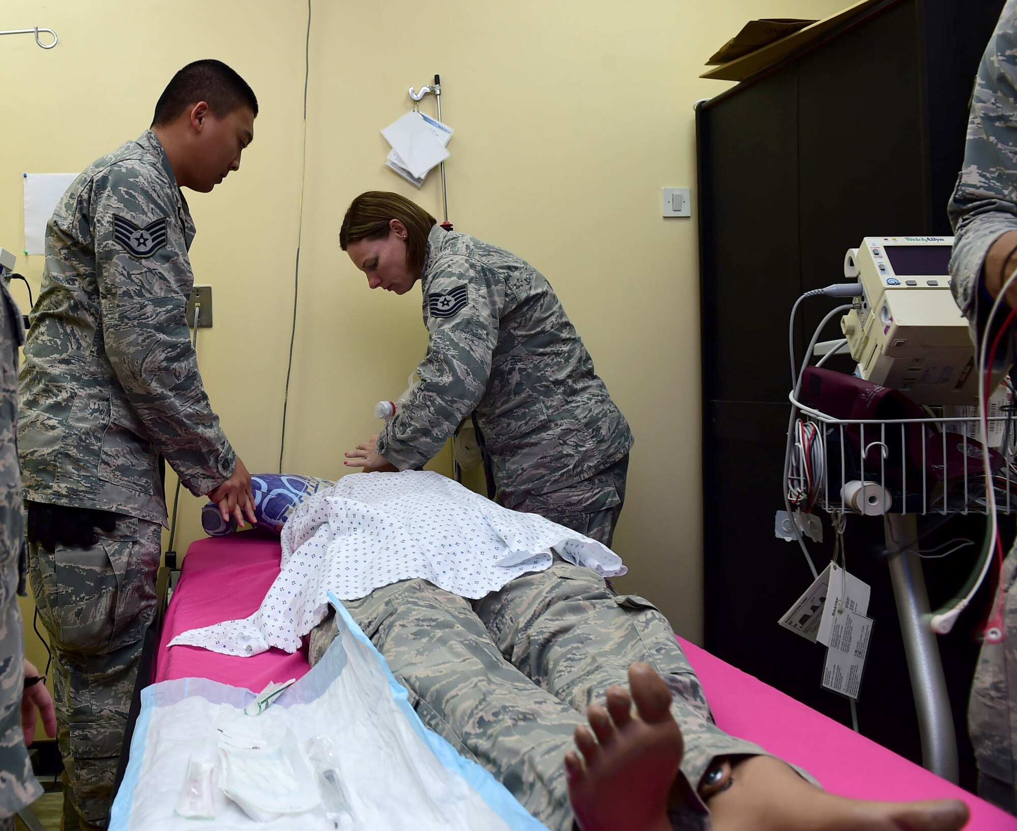 Staff Sgt. Montini Soriano and Tech. Sgt. Kristy Bussey, both 386th Expeditionary Medical Group medical technicians, perform CPR on a mock patient during a Code Blue exercise at an undisclosed location in Southwest Asia, Nov. 28, 2015. The purpose of the exercise is to assess the team’s readiness in the event of a medical emergency. (U.S. Air Force photo by Staff Sgt. Jerilyn Quintanilla)