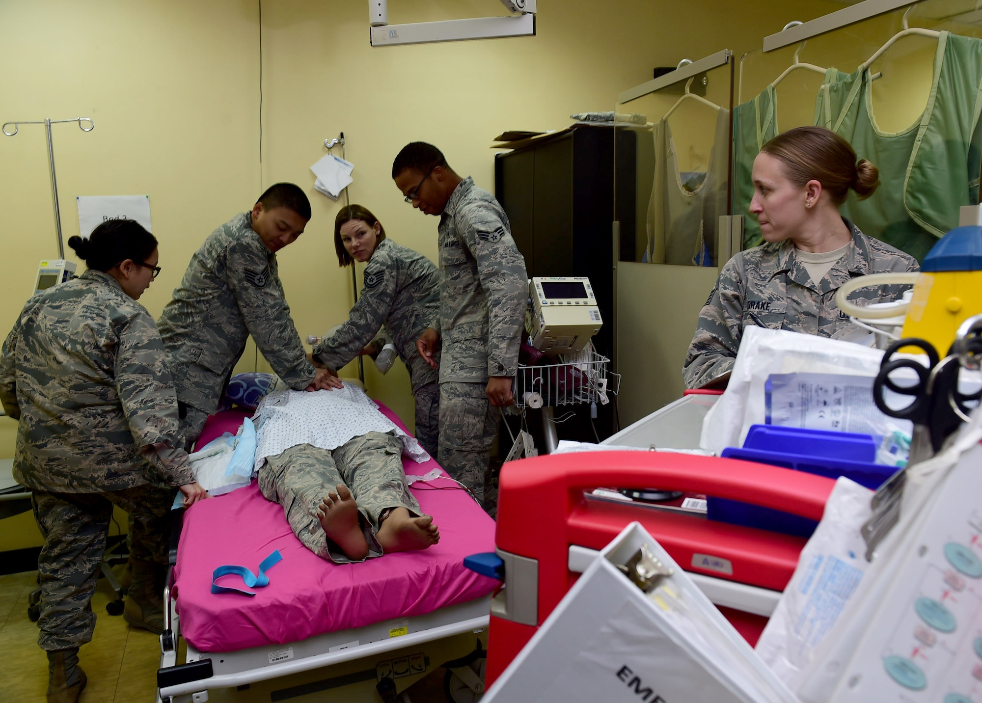 Members from the 386th Expeditionary Medical Group work together to coordinate emergency interventions during a Code Blue exercise at an undisclosed location in Southwest Asia, Nov. 28, 2015. The pupose of the exercise is to assess the team’s readiness in the event of a medical emergency. (U.S. Air Force photo by Staff Sgt. Jerilyn Quintanilla)
