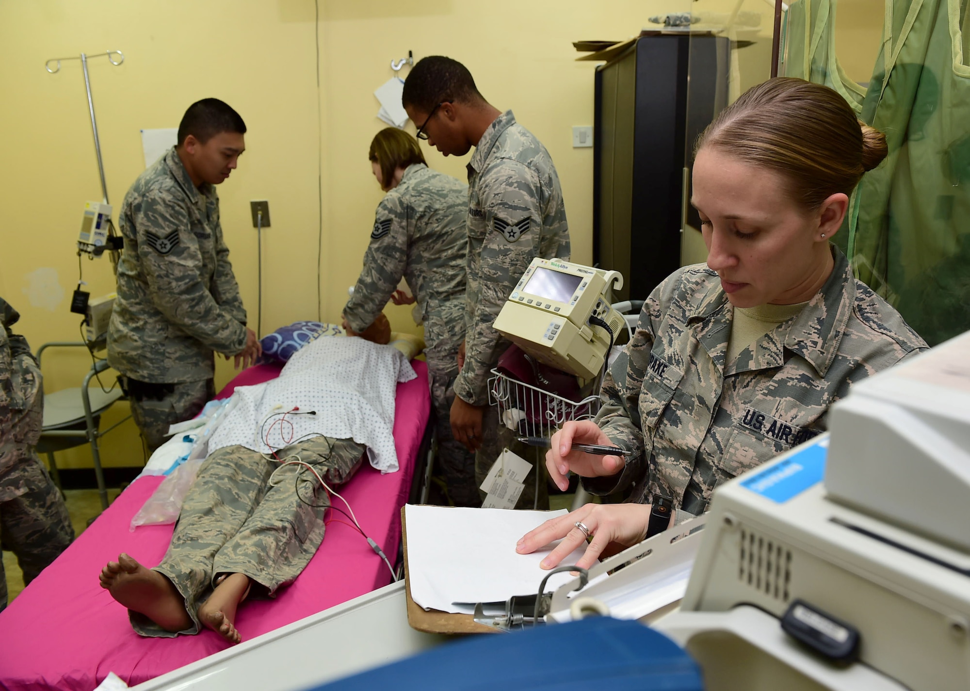Staff Sgt. Jennifer Drake, 386th Expeditionary Medical Group medical technician, records treatment procedures during a Code Blue exercise at an undisclosed location in Southwest Asia, Nov. 28, 2015. Comprised of more than 40 Airmen, the medical group is responsible for providing care to more than 3,500 U.S. and coalition forces supporting Operation INHERENT RESOLVE. (U.S. Air Force photo by Staff Sgt. Jerilyn Quintanilla) 