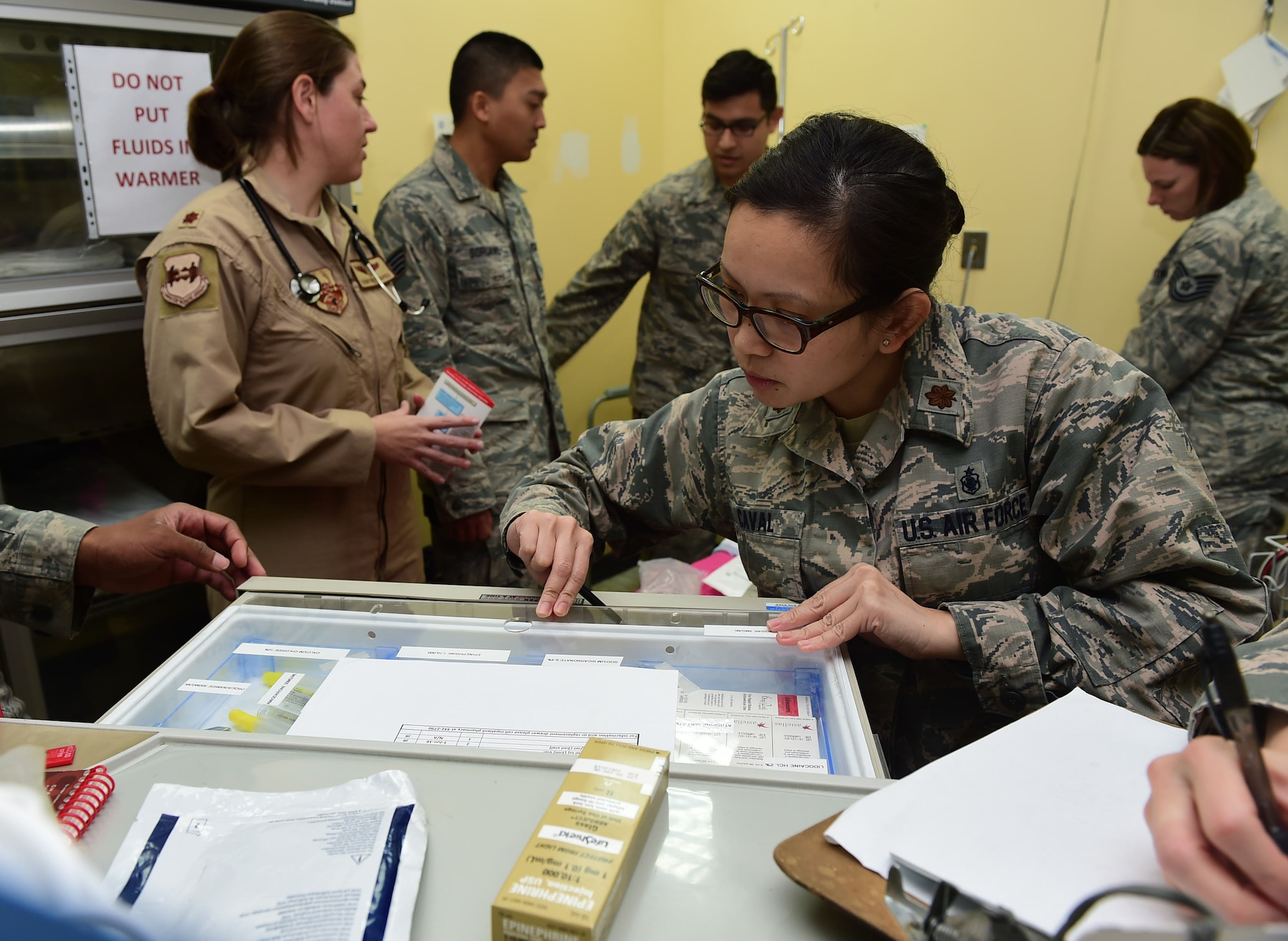 Maj. Jennie Caval, 386th Expeditionary Medical Group chief nurse, searches for medication to administer to a mock patient during a Code Blue exercise at an undisclosed location in Southwest Asia, Nov. 28, 2015. The 386th EMDG conducts monthly exercises as a way to practice their skills and assess the team’s readiness in the event of a medical emergency. (U.S. Air Force photo by Staff Sgt. Jerilyn Quintanilla)