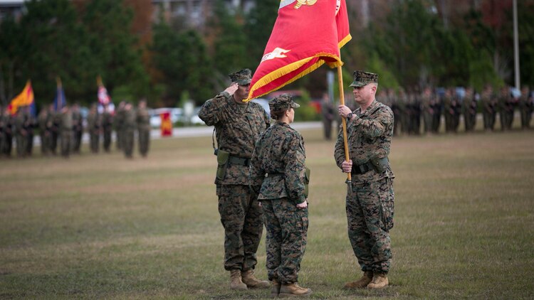 Lt. Col. David Morris passes the battalion colors to Lt. Col. Lauren Edwards during the 8th Engineer Support Battalion change of command ceremony at Camp Lejeune, N.C., Nov. 30, 2015. “Being a commander is not just an honor, it’s not just a billet; I think it’s a charge to keep,” said Edwards. Edwards’ new responsibility, as the first female commander of an ESB, will be to provide engineer support to II Marine Expeditionary Forces. 