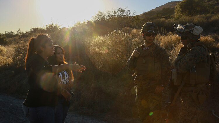 Marines with 1st Law Enforcement Battalion, I Marine Expeditionary Force Headquarters Group, I MEF attempt to de-escalate a hostile exchange with role-players during mobile immersion training aboard Marine Corps Base Camp Pendleton, Calif., Nov. 20, 2015. Mobile immersion training is a scenario-based training exercise in which the Marines engage in locating, apprehending and transporting a high-value individual.