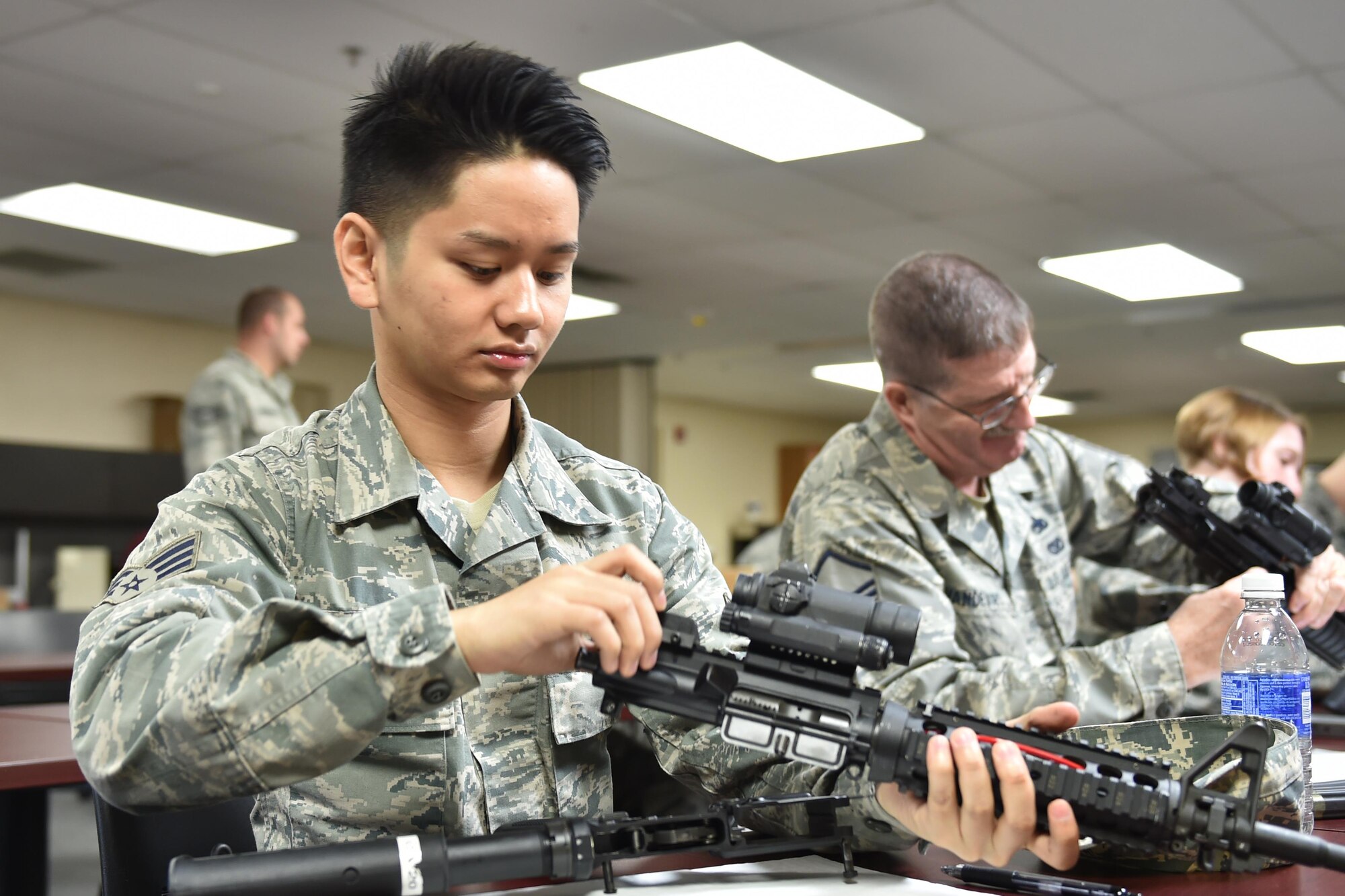 Senior Airman Khang Sabre-Nguyen, a member of the 910th Civil Engineer Squadron, assembles his M4 rifle during a qualification course here Nov. 7, 2015. Airmen are required to pass regular qualification courses on the M4 rifle. (U.S. Air Force photo/Tech. Sgt. James Brock)