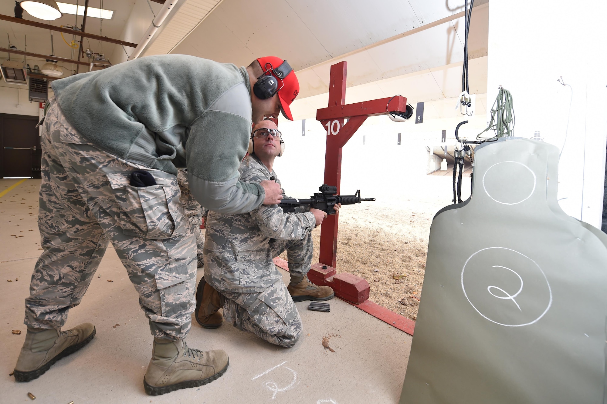 Tech. Sgt. Thomas Harris, a 910th Security Forces Squadron Combat Arms Instructor, instructs Staff Sgt. Brian Young, a member of the 910th Civil Engineer Squadron, during the M4 Rifle qualification course here Nov. 7, 2015. Airmen are required to pass regular qualification courses on the M4 rifle. (U.S. Air Force photo/Tech. Sgt. James Brock)