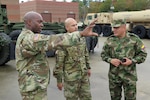 U.S. Army 1st Lt. Omar Benjamin (left), with the South Carolina Army National Guard’s Combined Support Maintenance Shop, answers questions from Colombian Army Lt. Col. Hernando Rodriguez through Army National Guard Sgt. 1st Class Alexander Lombana, Nov. 19, 2015. The South Carolina National Guard held a Subject Matter Expert Exchange with its Partner Nation Nov. 15-21, 2015. While in South Carolina, the five Colombian officers toured various sites and met with their National Guard counterparts seeing firsthand the areas affected by the floods, and how the Guard responded working alongside civilian first responders and state and local emergency management. Since its launch in 2012, when the South Carolina National Guard introduced its State Partnership Program (SPP) with the Republic of Colombia, S.C., has focused on establishing long-term relationships where Colombia and South Carolina can promote mutual interests and build lasting capabilities. In the past year the South Carolina National Guard has held 26 engagements with its partner nation. (U.S. Air Force photo by 1st Lt. Stephen D. Hudson)