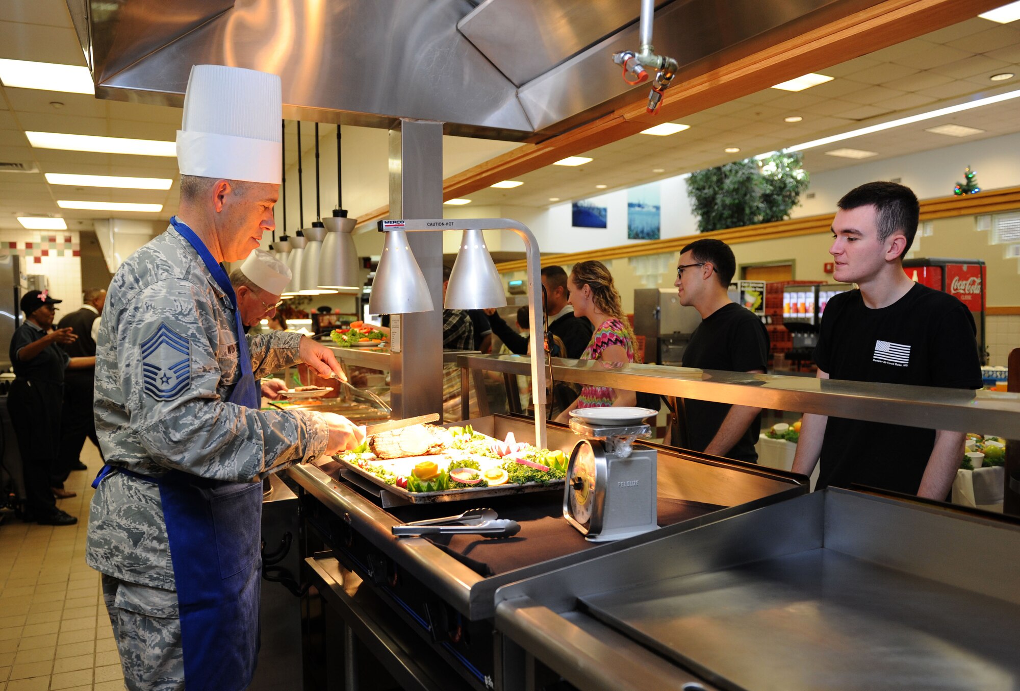 Chief Master Sgt. Robert Winters, 81st Training Group superintendent, serves meals to Airmen at the Azalea Dining Facility on Thanksgiving Day, Nov. 26, 2015, Keesler Air Force Base, Miss. It is tradition at Keesler for commanders, first sergeants and superintendents to take time out of their holiday to serve a Thanksgiving meal at the dining facilities to technical training Airmen and Airmen in the dorms. (U.S. Air Force Photo by Kemberly Groue)
