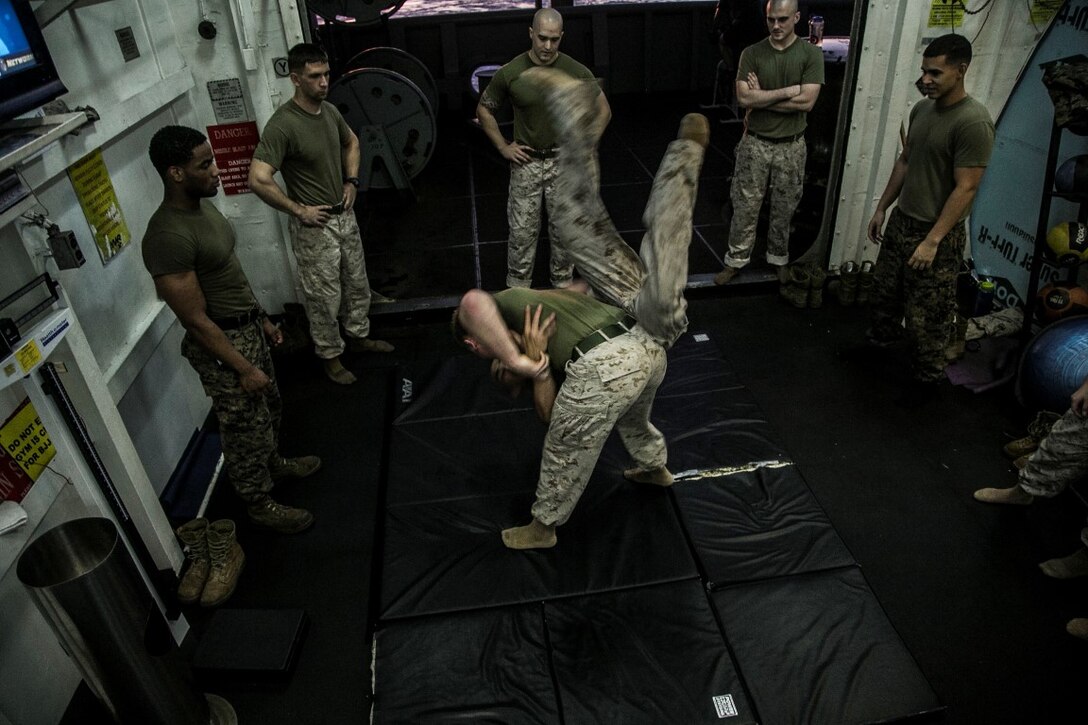 PACIFIC OCEAN (Nov. 25, 2015) U.S. Marines with Marine Medium Tiltrotor Squadron 161 (Reinforced), 15th Marine Expeditionary Unit, hit the mats during a Marine Corps Martial Arts Program course aboard the USS Essex (LHD 2). The 15th MEU is currently deployed in the Indo-Asia-Pacific region to promote regional stability and security in the U.S. 7th Fleet area of operations. (U.S. Marine Corps photo by Cpl. Elize McKelvey/Released)
