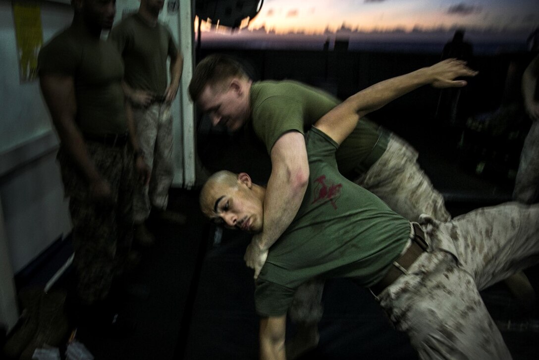 PACIFIC OCEAN (Nov. 25, 2015)  U.S. Marines with Marine Medium Tiltrotor Squadron 161 (Reinforced), 15th Marine Expeditionary Unit, hit the mats during a Marine Corps Martial Arts Program course aboard the USS Essex (LHD 2). The 15th MEU is currently deployed in the Indo-Asia-Pacific region to promote regional stability and security in the U.S. 7th Fleet area of operations. (U.S. Marine Corps photo by Cpl. Elize McKelvey/Released)