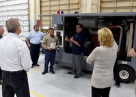 Freddy Roblez, 97th Maintenance Directorate, U.S. Air Force KC-46 Pegasus refueling aircraft maintenance supervisor and Art Smith, Boeing, KC-46 logistics supply representative at Altus Air Force Base, Okla., brief members of the 97th MX about a new air start car that will be used for the KC-46, Dec. 1, 2015, at the 97th MX, KC-46 maintenance unit at Altus Air Force Base, Okla. The air start car will be used to help start engines on the new KC-46 aircrafts scheduled to arrive here February 2017. (U.S. Air Force photo by Senior Airman Franklin R. Ramos/Released)