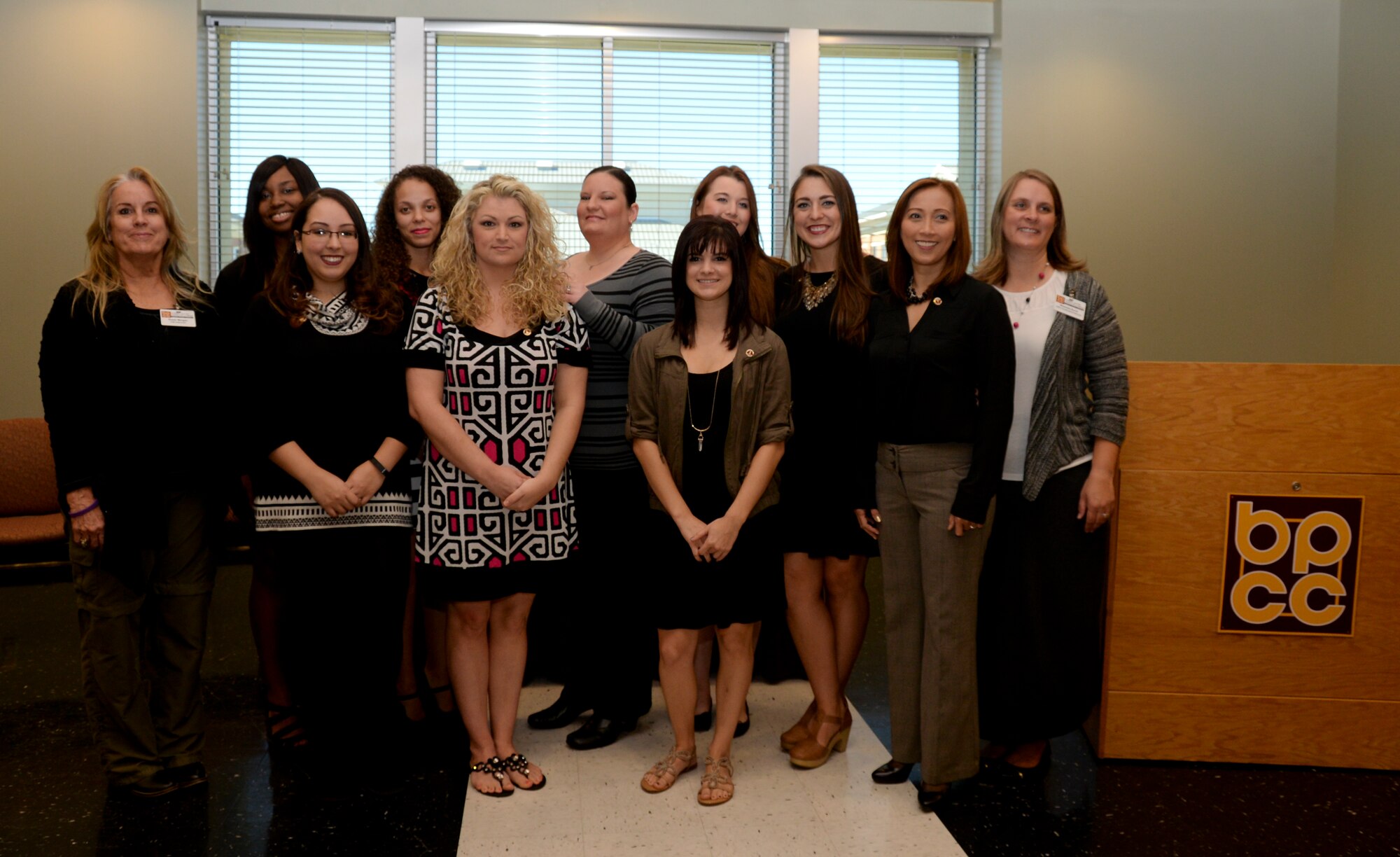 Spouses from Barksdale Air Force Base, La., and fellow students pose for a photo after receiving their certification from the certified nurse assistant course at Bossier Parish Community College, Bossier City, La., Nov. 20, 2015. The ten-week course prepares students to work with long-term care patients. Students learn through instruction in medical terminology, patient care, on-site clinical and practice lab situations. (U.S. Air Force photo/Senior Airman Amanda Morris)