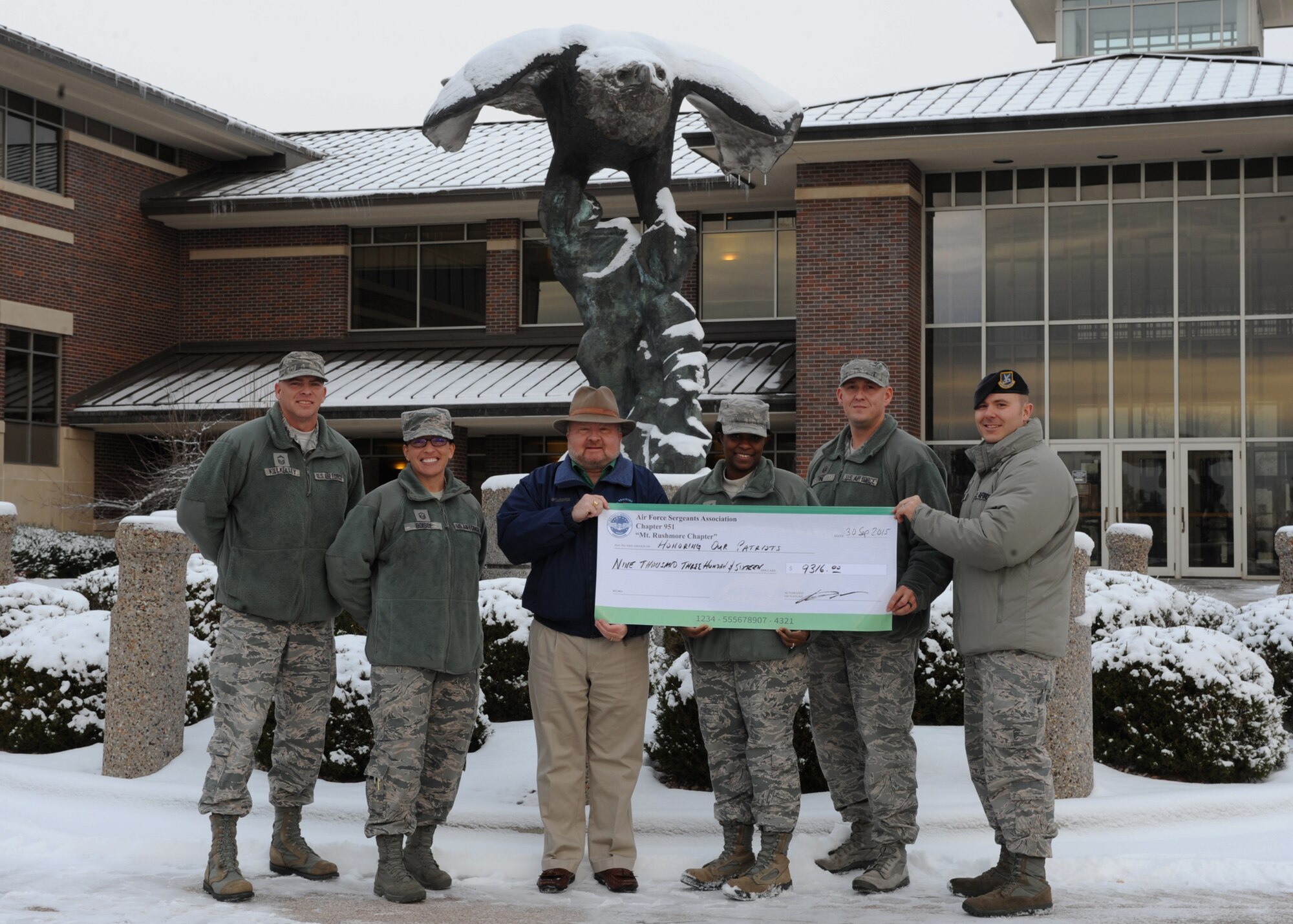 Kevin Ott, center, Air Force Sergeants Association Chapter 951 special event coordinator, poses with members of base private organizations in conclusion of the annual Combined Federal Campaign at Ellsworth Air Force Base, S.D., Nov. 30, 2015. More than 10 base organizations donated more than $9,000 to two CFC charities, the Gary Sinise Foundation & Intrepid Fallen Heroes Fund. The CFC is designed to provide servicemembers and Department of Defense civilians an opportunity to contribute to their choice of approved local and national charities during a designated period of time. (U.S. Air Force photo by Airman 1st Class Denise M. Nevins/Released)