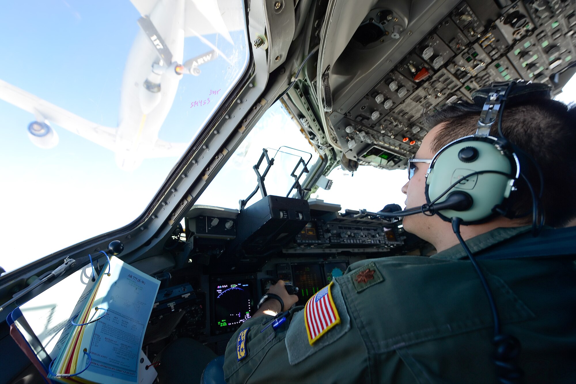 Maj. Richard Robichaud, 436th Airlift Wing Command Post chief and C-17A Globemaster III pilot, moves into position to refuel from a KC-135R Stratotanker of the 117th Air Refueling Wing, Alabama Air National Guard Nov. 23, 2015, from Dover Air Force Base, Del. The refueling was done during the 2015 Dover AFB  Honorary Commanders 436th Operations Group orientation flight. (U.S. Air Force photo/Greg L. Davis)