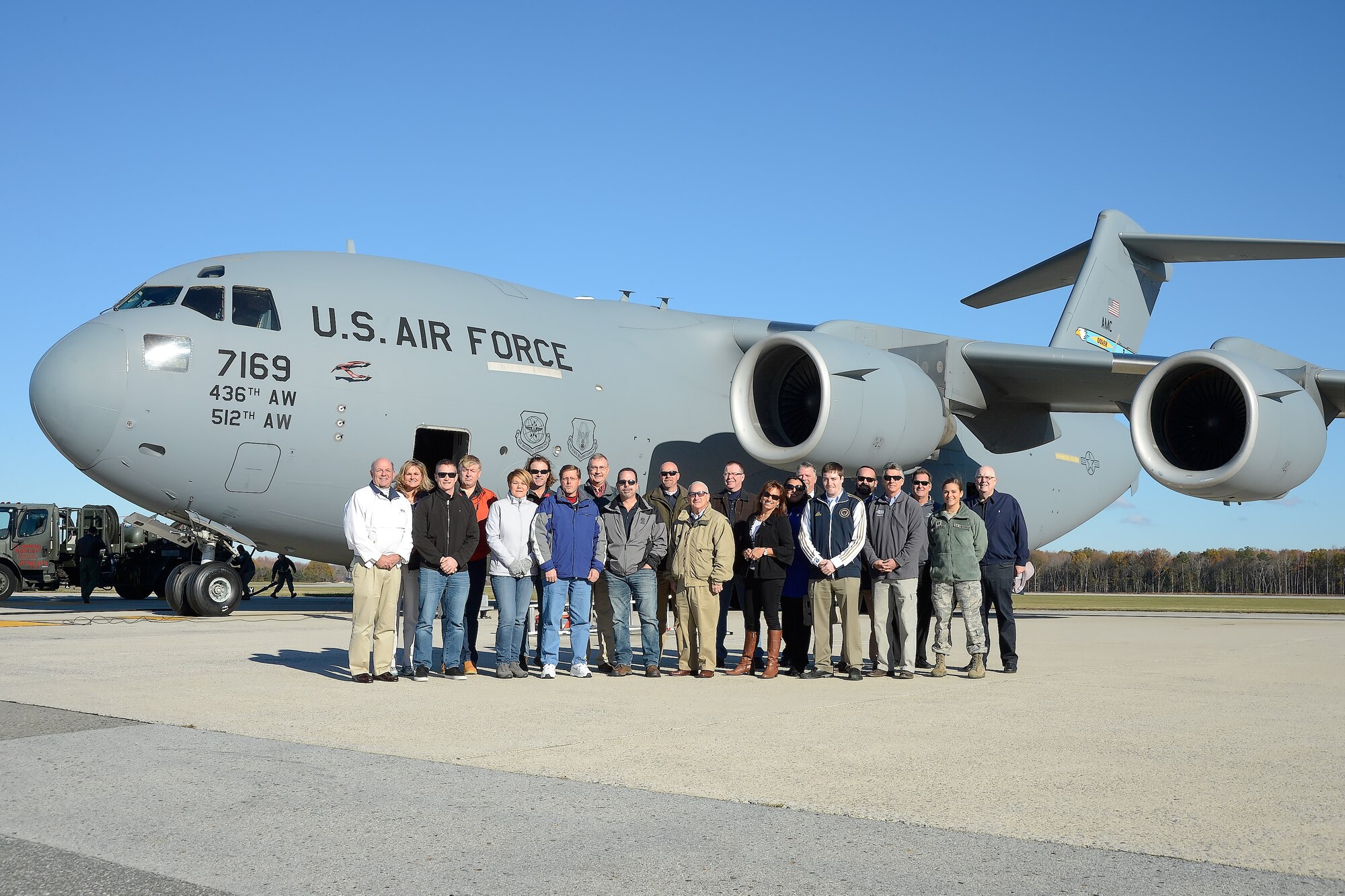 The 2015 Dover Air Force Base Honorary Commanders pose for a group photo in front of a C-17A Globemaster III during a tour of the 436th Operations Group Nov. 23, 2015, at Dover Air Force Base, Del. The honorary commanders witnessed in-flight refueling training with a KC-135R Stratotanker of the 117th Air Refueling Wing, Alabama Air National Guard. (U.S. Air Force photo/Greg L. Davis)