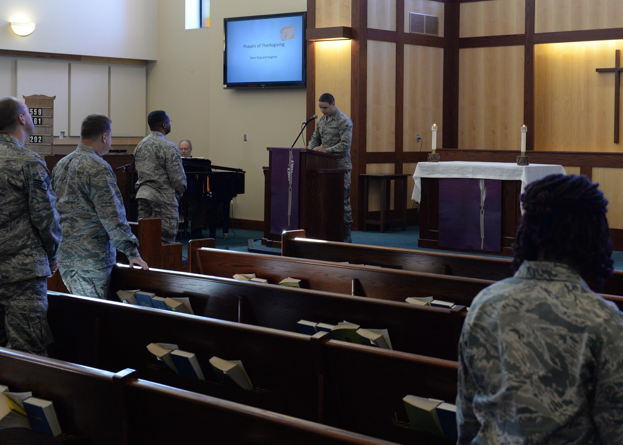 Airman 1st Class Raynard Hughes 736th Aircraft Maintenance Squadron aerospace propulsion apprentice, reads a prayer of thanksgiving by Naomi King at the Dover Ecumenical Thanksgiving service Nov. 23, 2015, at the Chapel on Dover Air Force Base, Del. Raynard spoke about the importance of giving and being thankful during the holiday season. (Courtesy photo)