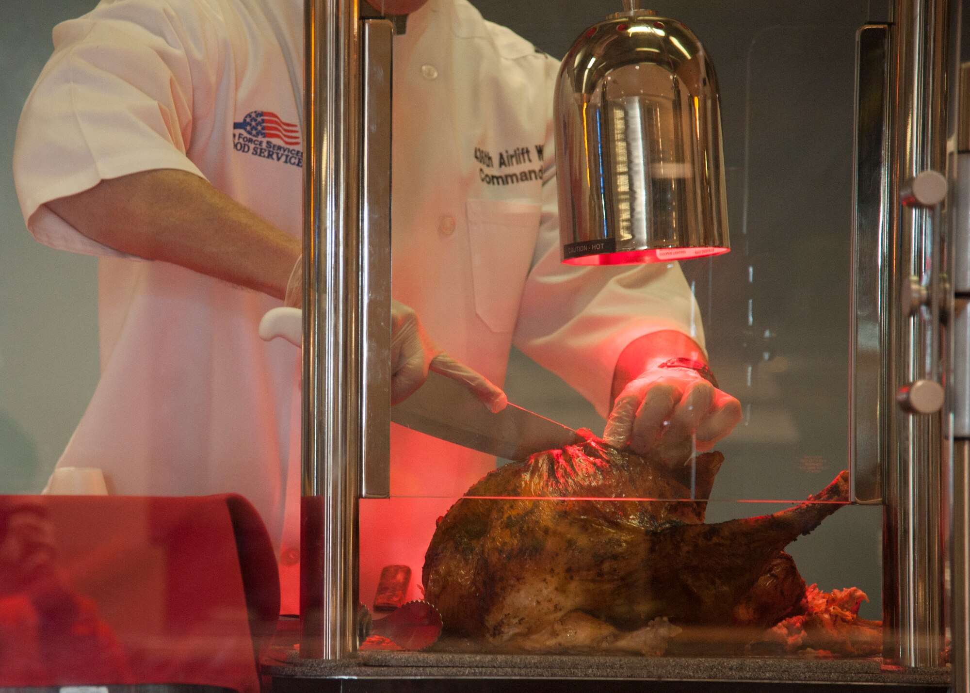 Col. Michael Grismer, 436th Airlift Wing commander, carves the Thanksgiving turkey at the Patterson Dining Facility Nov. 26, 2015, on Dover Air Force Base, Del. Grismer along with other Team Dover leadership volunteered their time to serve the Thanksgiving feast. (U.S. Air Force photo/Staff Sgt. Jared Duhon) 