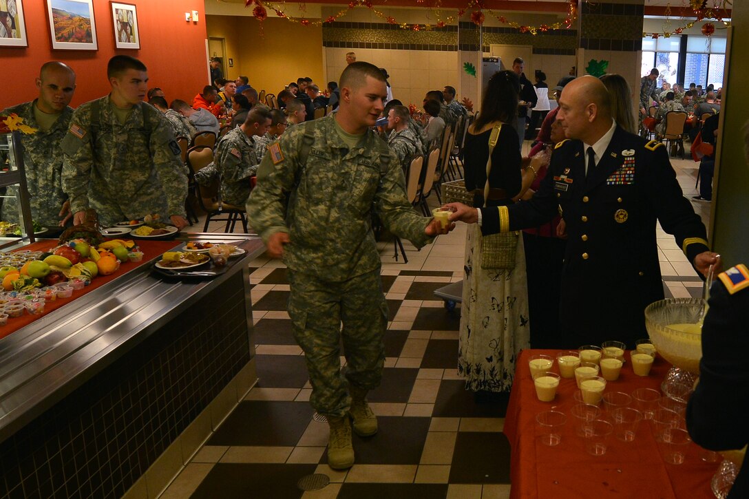 U.S. Army Maj. Gen. Anthony C. Funkhouser, the commander of the Center for Initial Military Training, hands out eggnog to Soldiers during one of Joint Base Langley-Eustis’ (JBLE) holiday meals at Fort Eustis, Va., Nov. 26, 2015. The JBLE leadership hosted holiday meals at each base ensuring Soldiers and U.S. Airmen were able to celebrate Thanksgiving with their military family. (U.S. Air Force photo by Staff Sgt. Natasha Stannard)