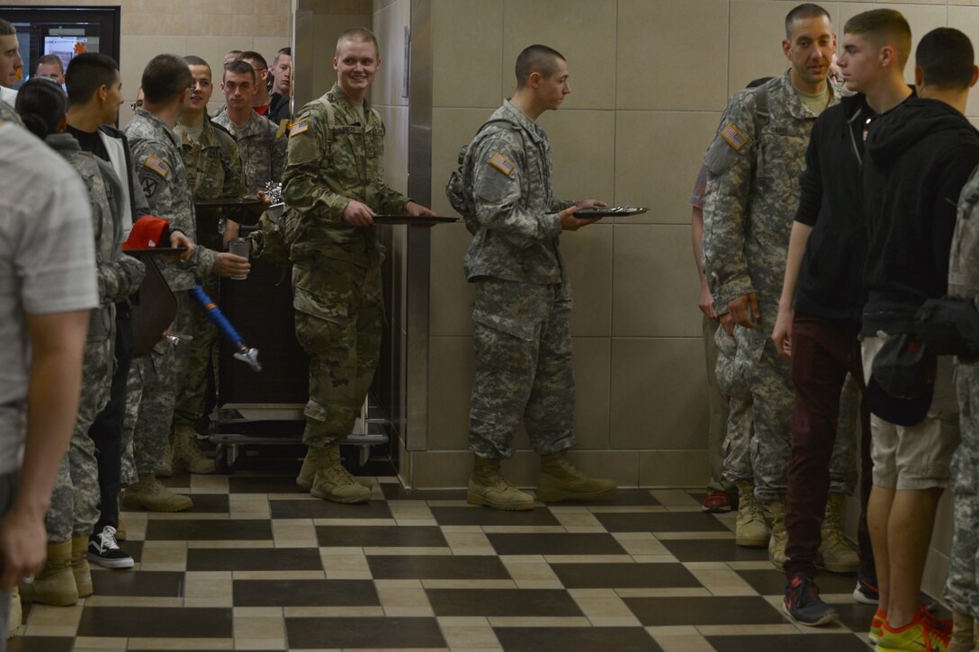 U.S. Army Soldiers line-up for a Thanksgiving meal at the Warrior Café Dining Facility at Fort Eustis, Va., Nov. 26, 2015. Approximately 1,300 Joint Base Langley-Eustis members attended the feast, which offered the traditional atmosphere and trimmings of a home cooked meal. (U.S. Air Force photo by Staff Sgt. Natasha Stannard)