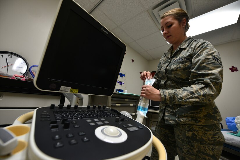 U.S. Air Force Airman 1st Class Chelsea Walker, an aerospace medical service technician assigned to the 633rd Medical Group, applies a sterile probe cover prior to a pelvic ultrasound probe at Langley Air Force Base, Va., Nov. 23, 2015. A pelvic ultrasound allows doctors to examine female reproductive organs and fetuses during gestation. (U.S. Air Force photo by Senior Airman Aubrey White)